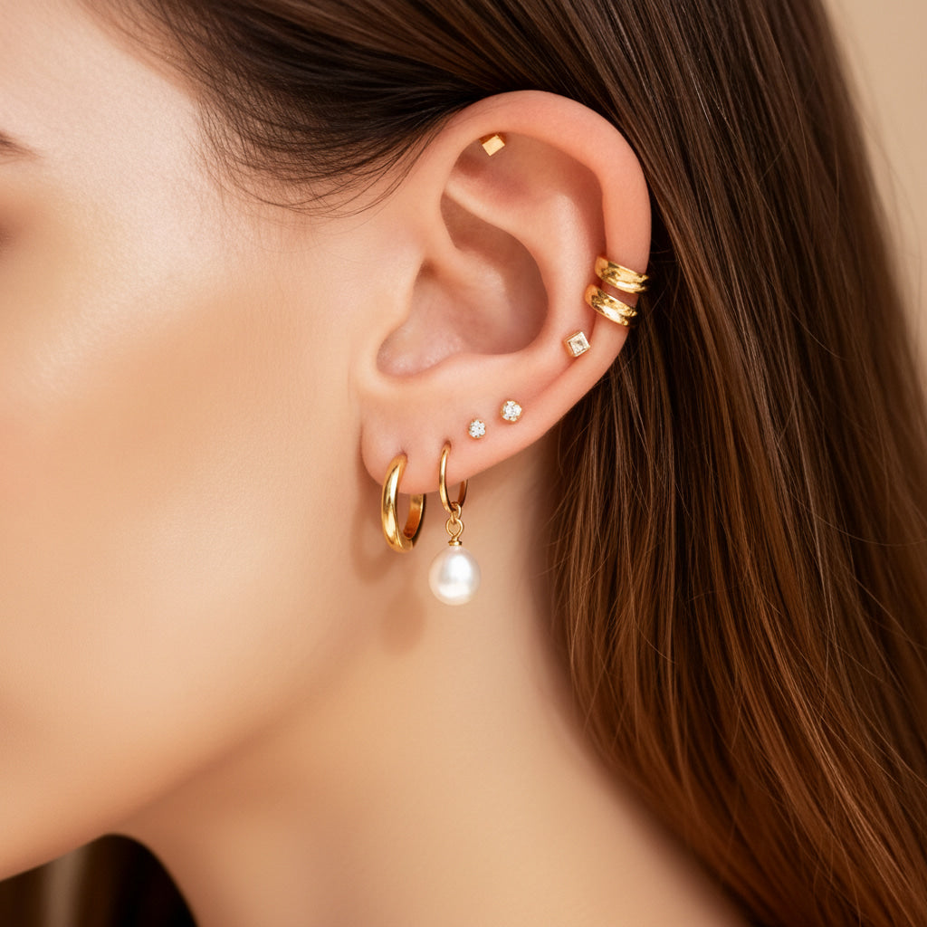 Gold 18k PVD earrings collection image for Glistia on neutral background