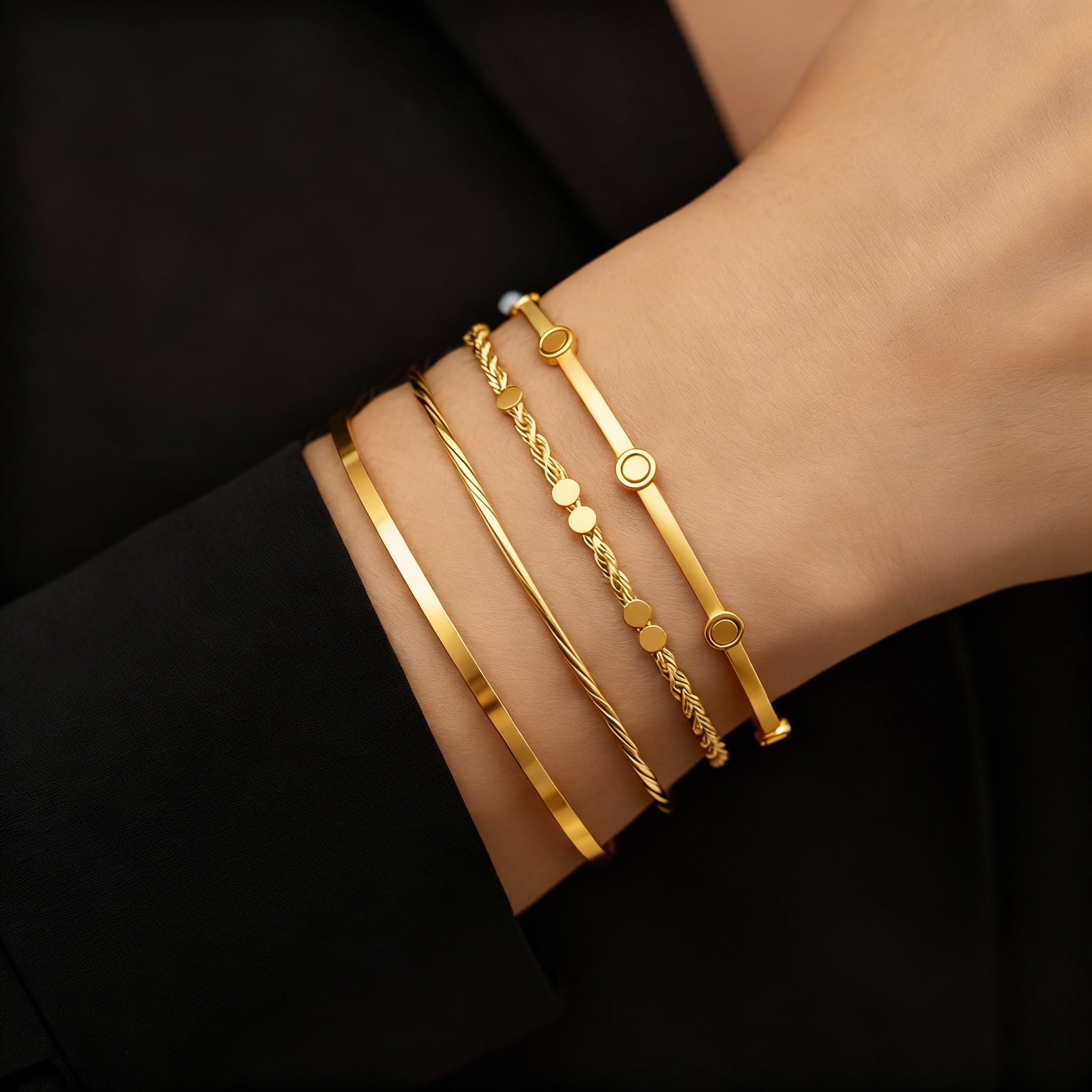 Model wearing gold bangles and bracelets for Glistia wristwear collection