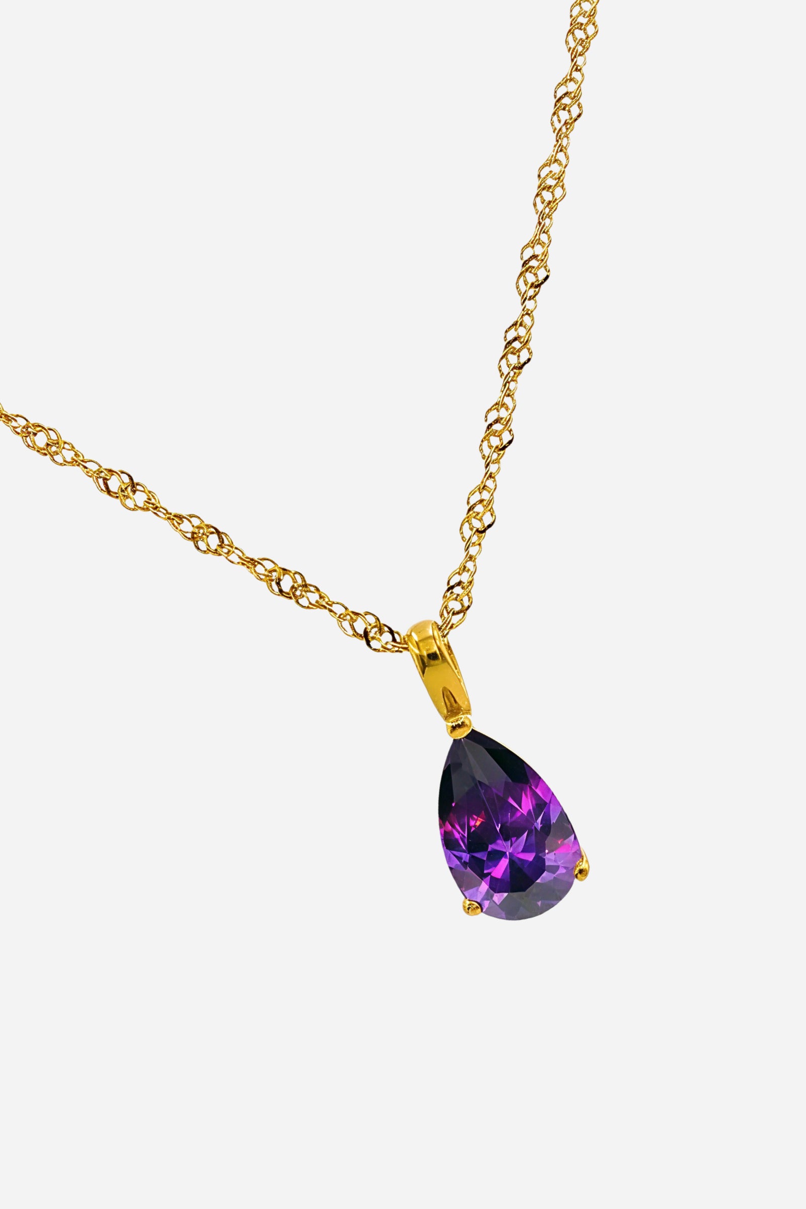 Side angle of amethyst birthstone pendant showing pear-cut violet zircon and gold finish – GLISTIA