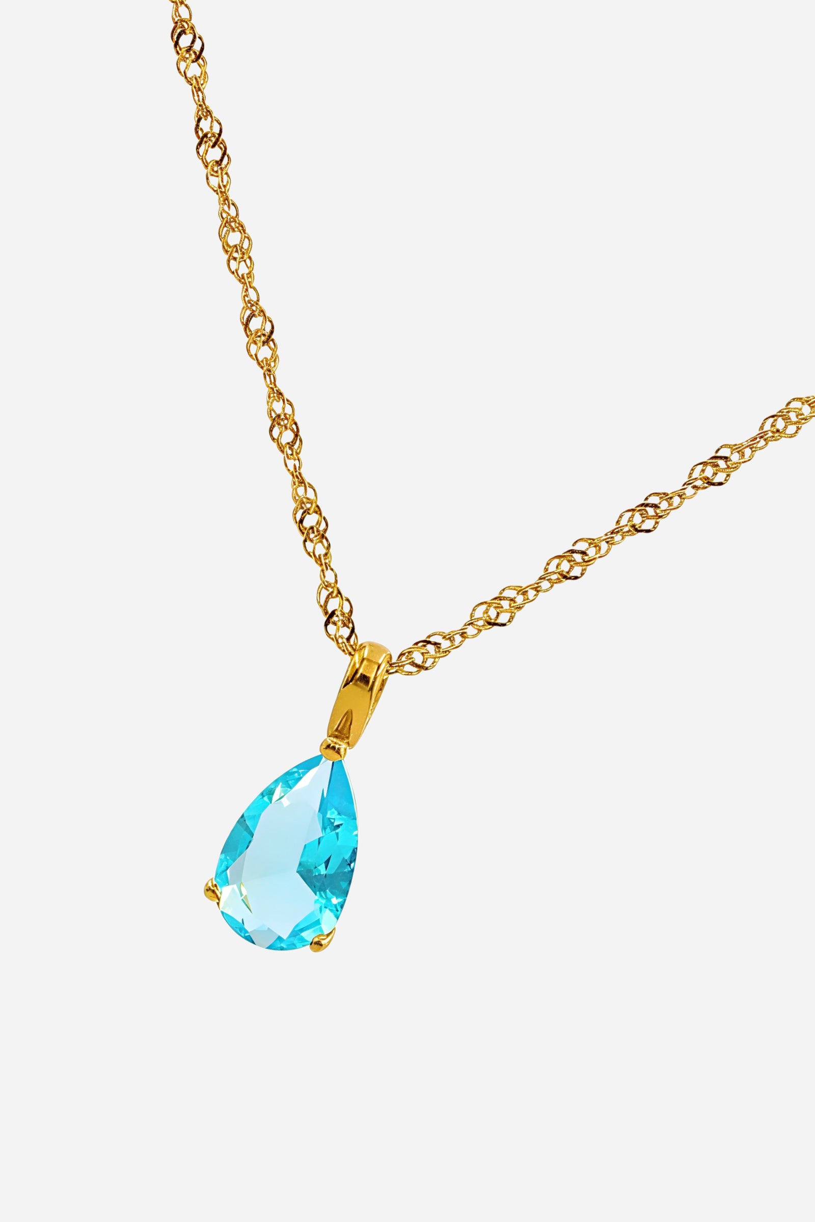 Side angle of March Aqua Birthstone Necklace showcasing the aqua blue zircon stone and polished gold finish – GLISTIA.