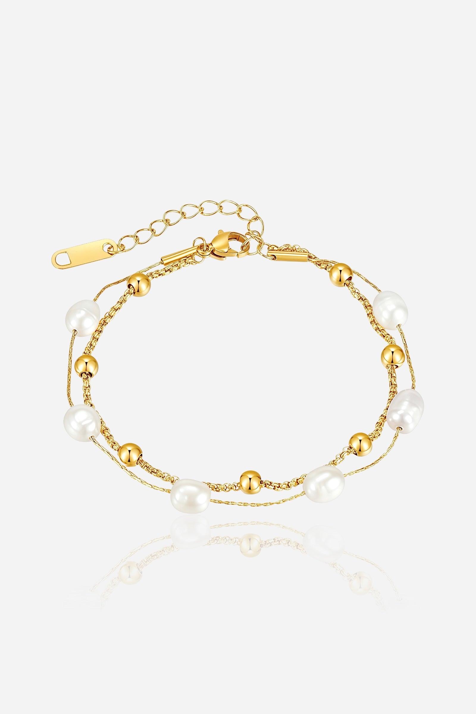 GLISTIA Aurora dual strand gold bead and pearl bracelet in PVD 18K gold plated stainless steel shown from the front.