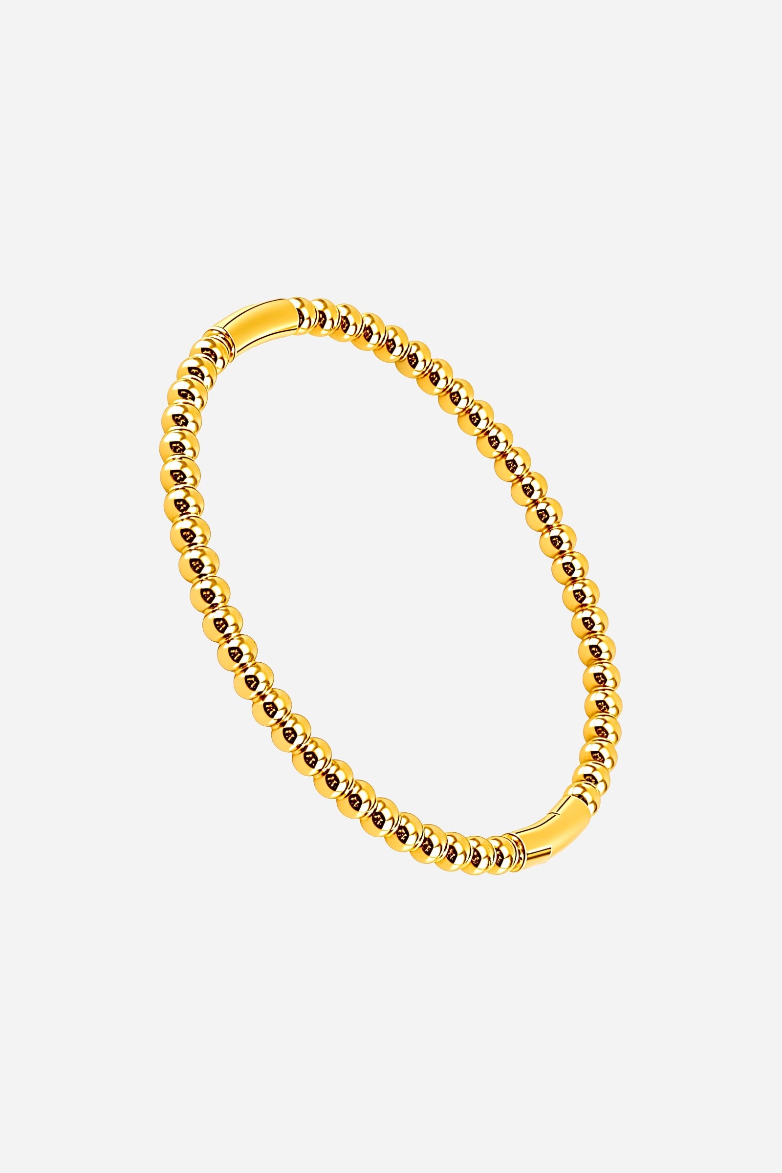 Top view of the Beaded Sphere Bangle highlighting the seamless loop of uniform gold spheres and glossy finish - GLISTIA