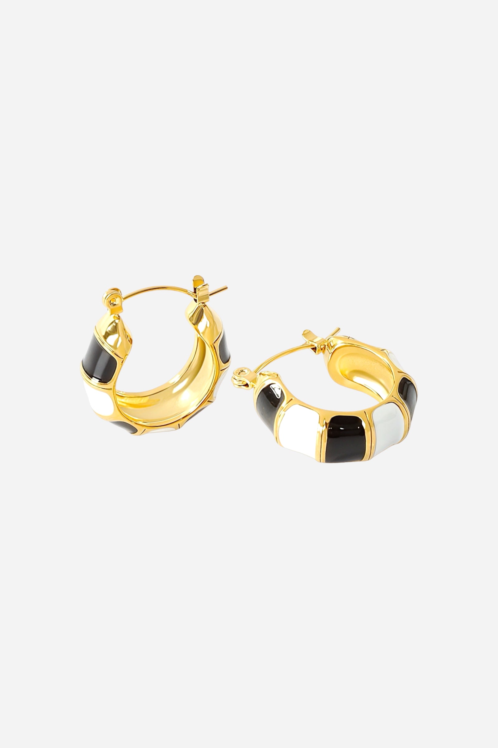 Side view of black and white enamel hoop earrings in 18K gold plated stainless steel featuring a bold striped enamel design with a smooth polished gold finish – GLISTIA jewellery