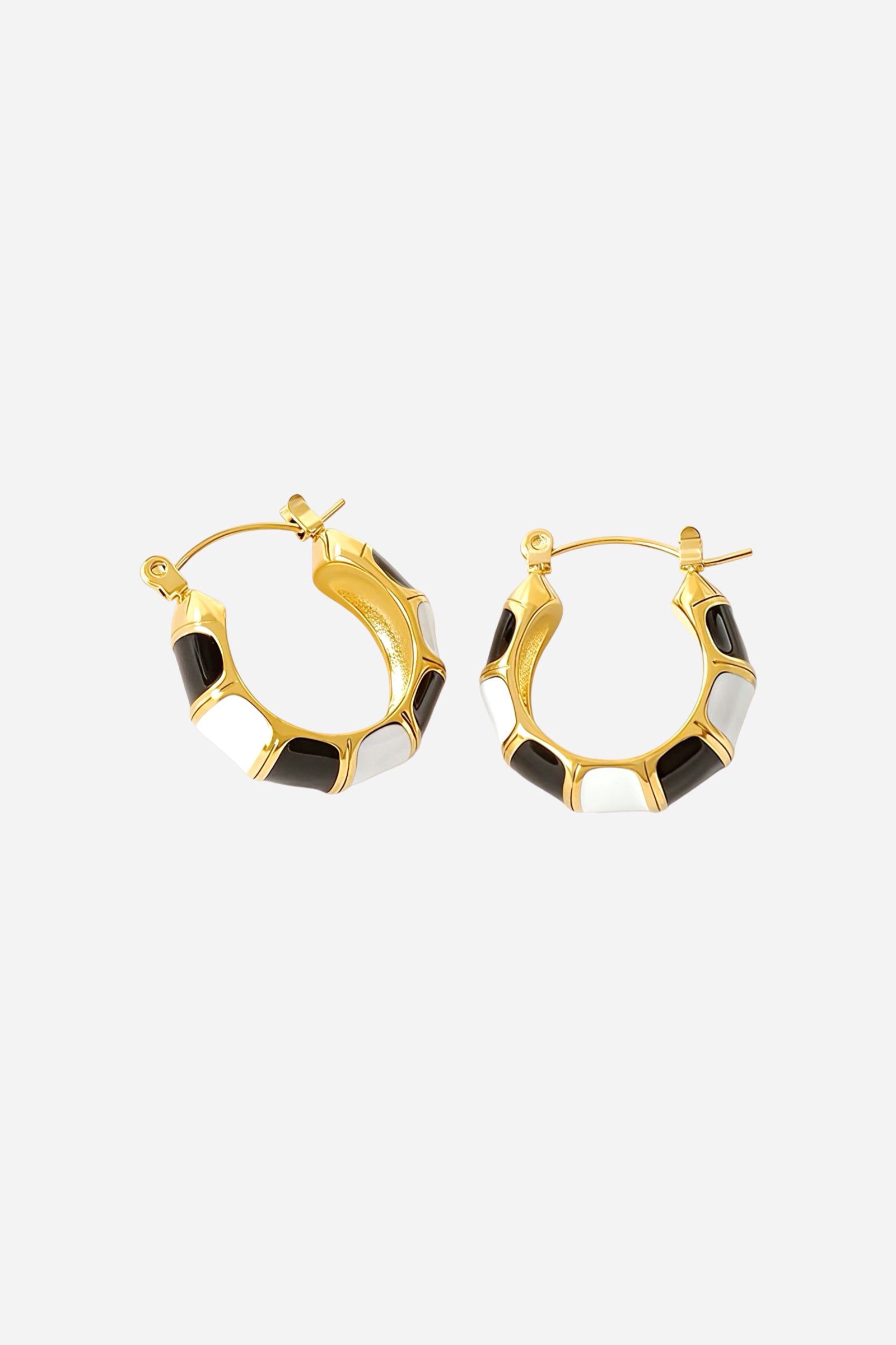 Top side view of black and white enamel hoop earrings in 18K gold plated stainless steel featuring alternating enamel panels and polished gold detailing – GLISTIA jewellery