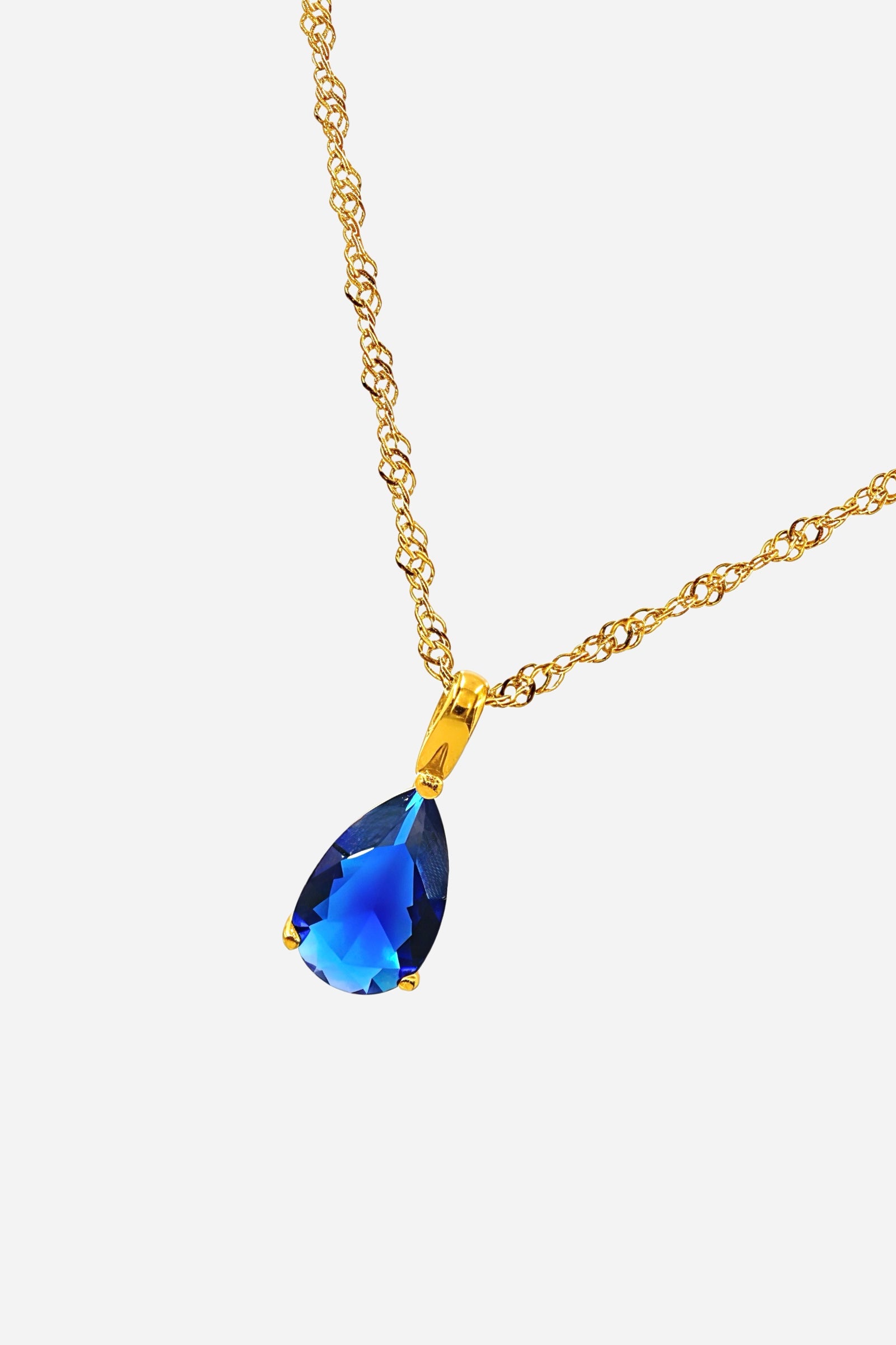 Blue Zircon Birthstone Necklace December – top angle showing gold chain and pear-cut blue zircon pendant by GLISTIA.