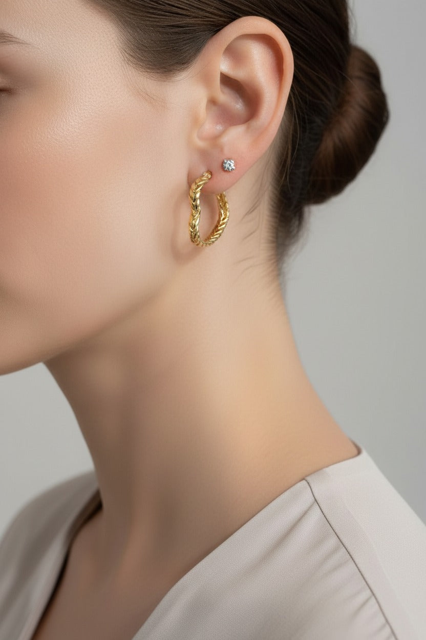 Braided heart hoop earrings in 18K PVD gold plated stainless steel worn on ear, romantic textured gold hoops by GLISTIA