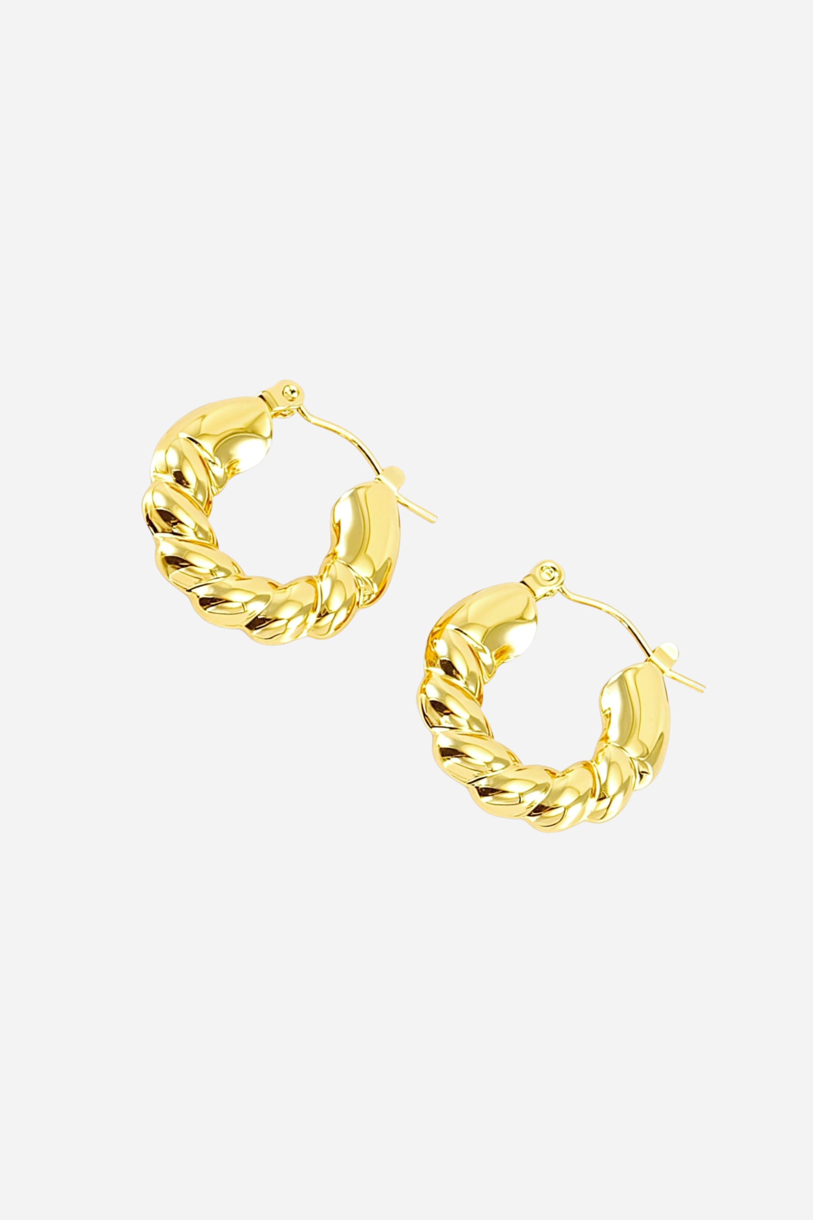 Angled view of braided twist hoop earrings crafted from stainless steel with a radiant PVD 18K gold plated finish, highlighting the sculpted interwoven design and reflective curved surface – GLISTIA.