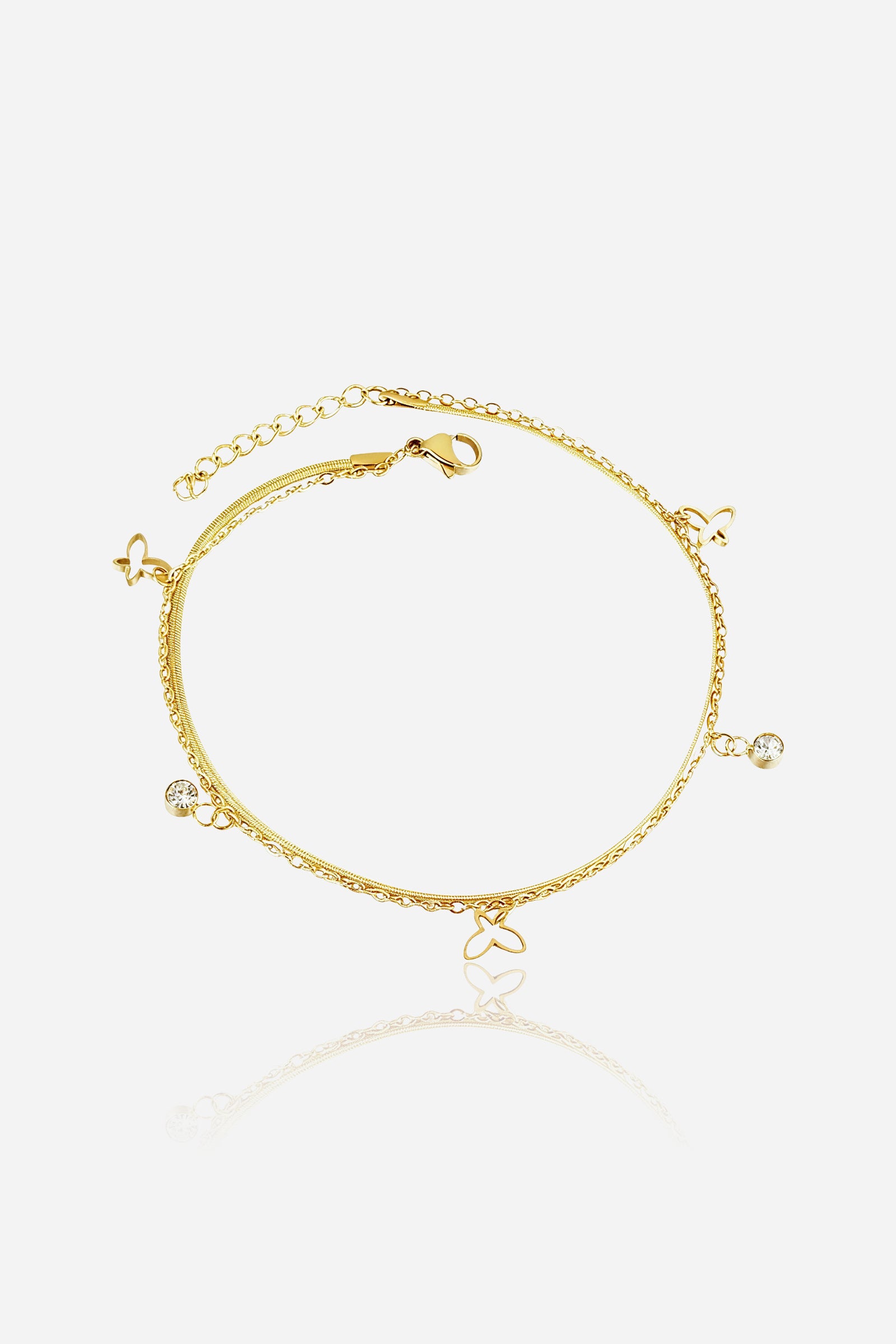 Top view of the gold Butterfly Charm Anklet showing layered chains with butterfly and crystal accents – GLISTIA.