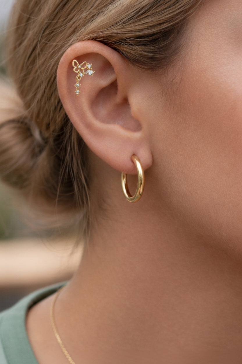 Single butterfly drop piercing stud earring in 18K PVD gold plating with cubic zirconia crystal drop