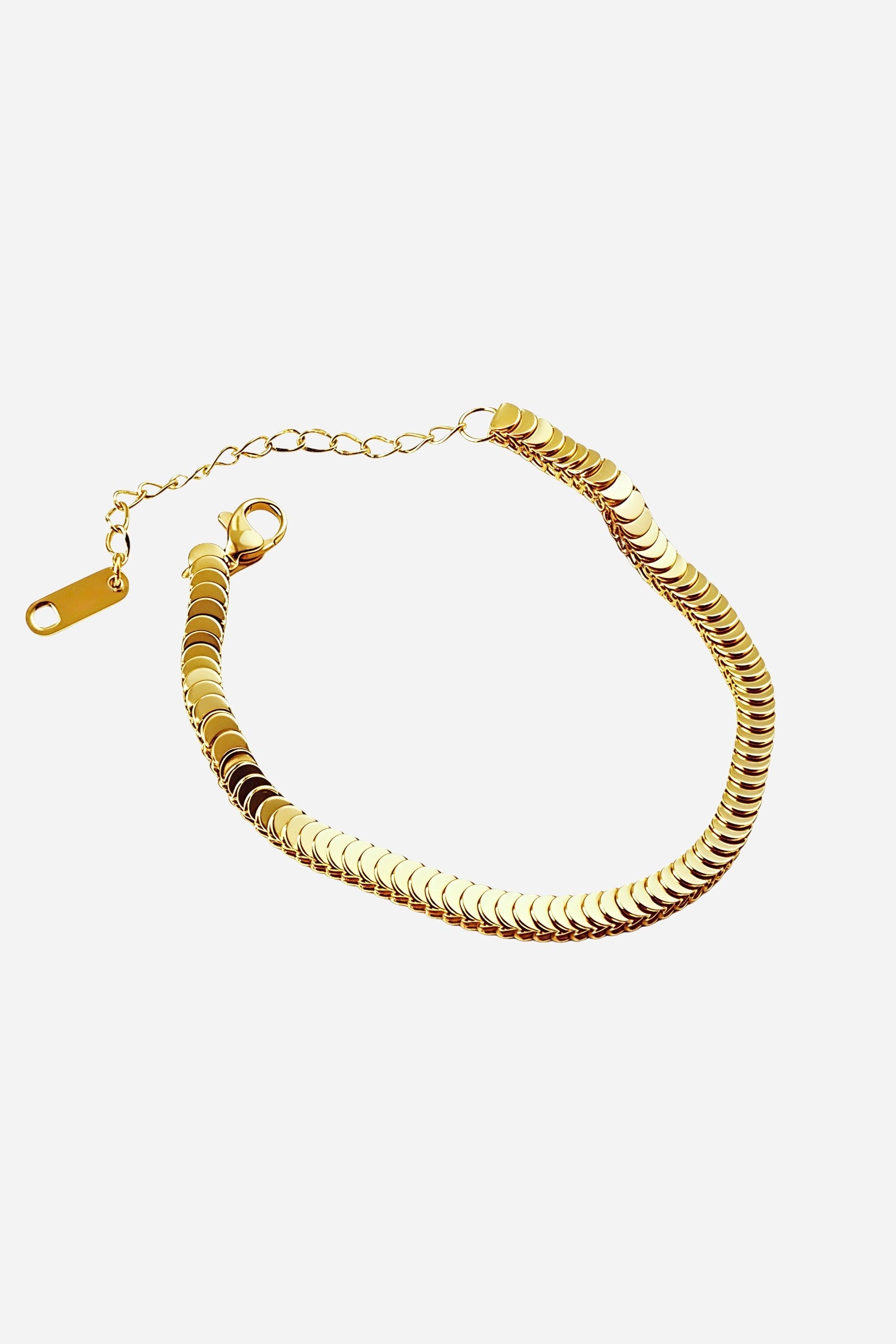 Side-angle view of the GLISTIA disc chain bracelet highlighting the reflective gold plating and smooth disc detail.