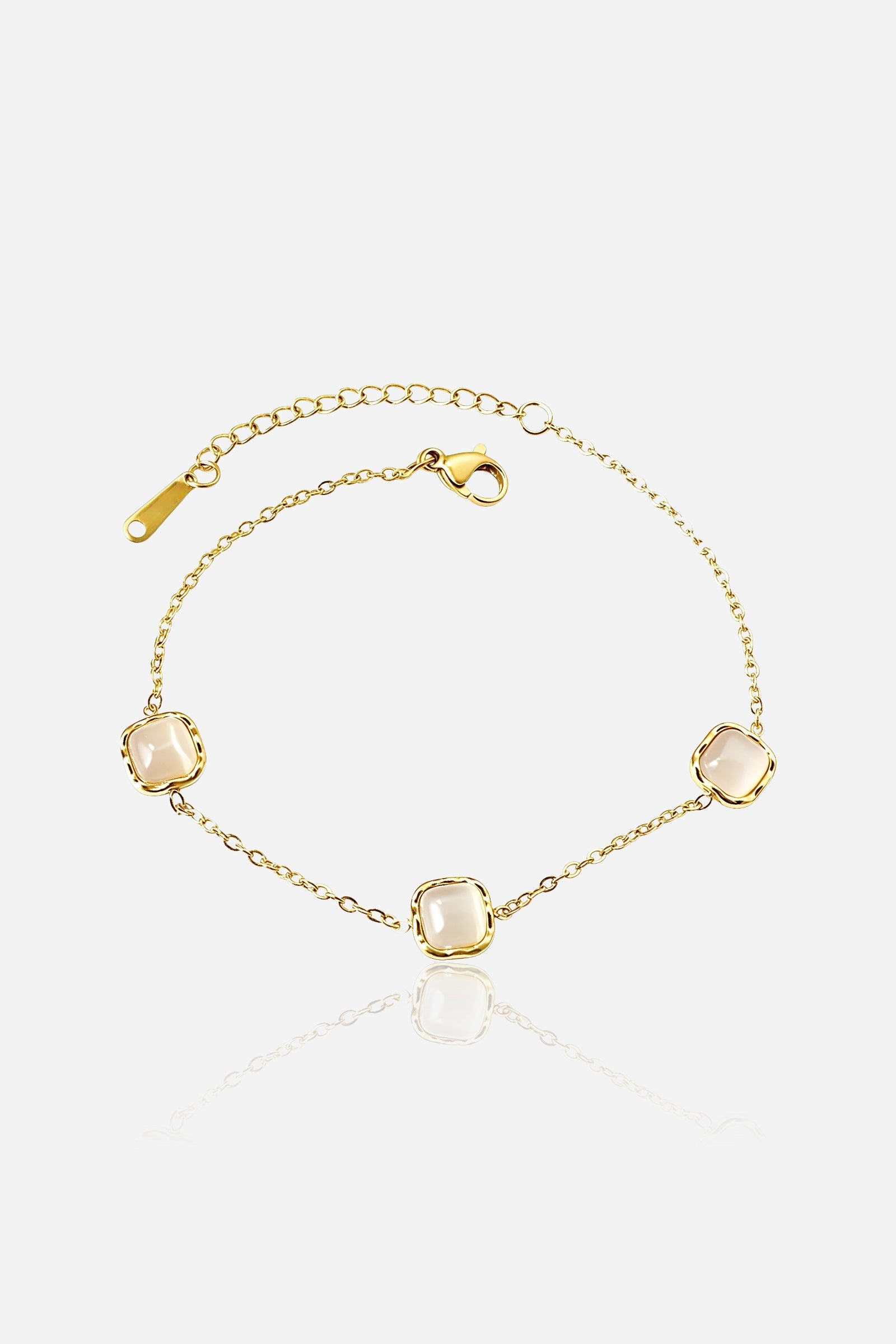 GLISTIA Celeste square gem bracelet in PVD 18K gold plated stainless steel shown from the front with soft square-cut imitation stones.