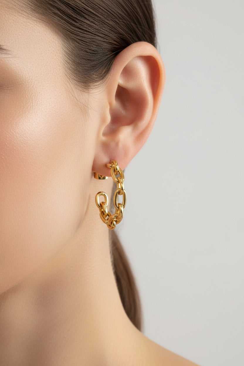 Chain link hoop earrings in 18K PVD gold plated stainless steel worn on ear, modern statement design by GLISTIA