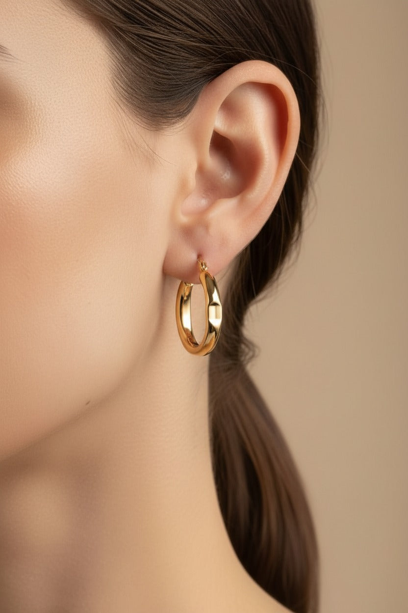 Chunky gold hoop earrings crafted from stainless steel with 18K PVD gold plating, featuring a smooth polished finish and classic bold design