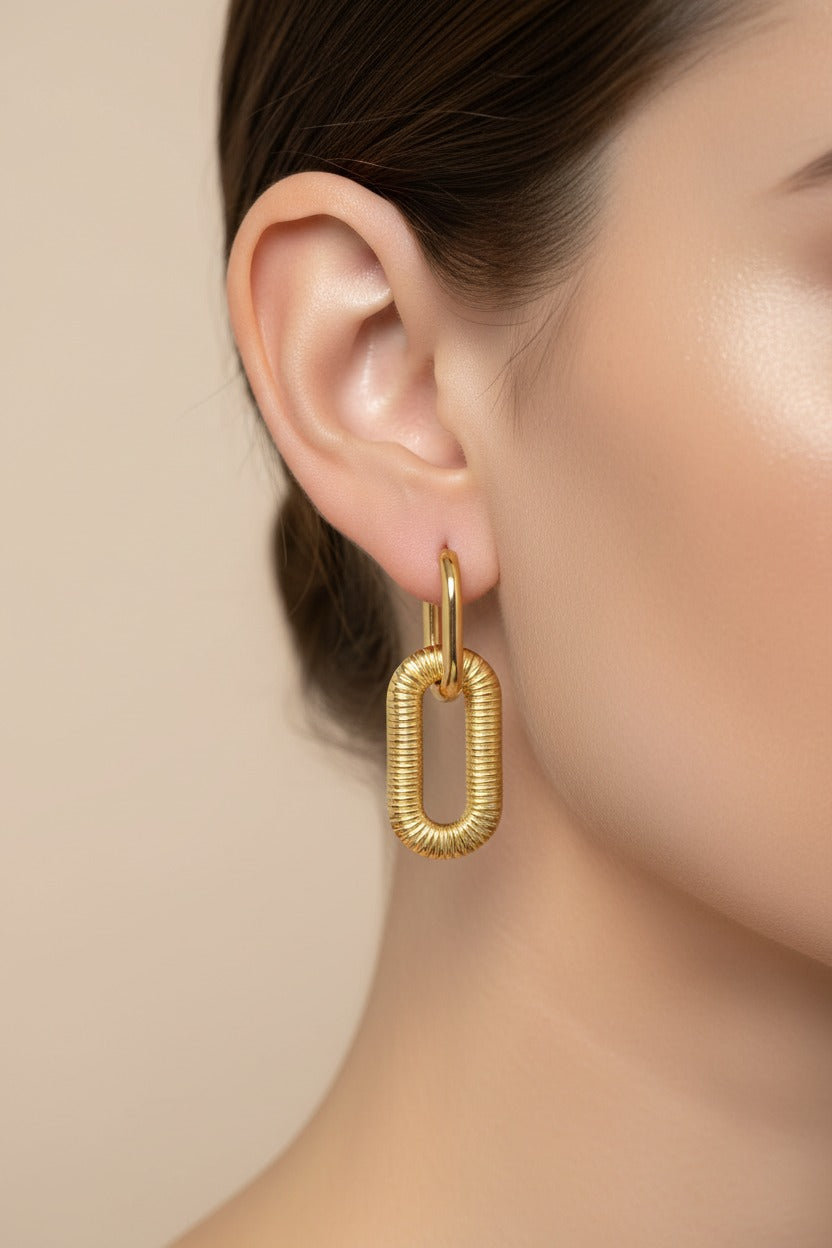 Chunky gold link drop earrings crafted from stainless steel with 18K PVD gold plating, featuring an oversized textured oval link design.