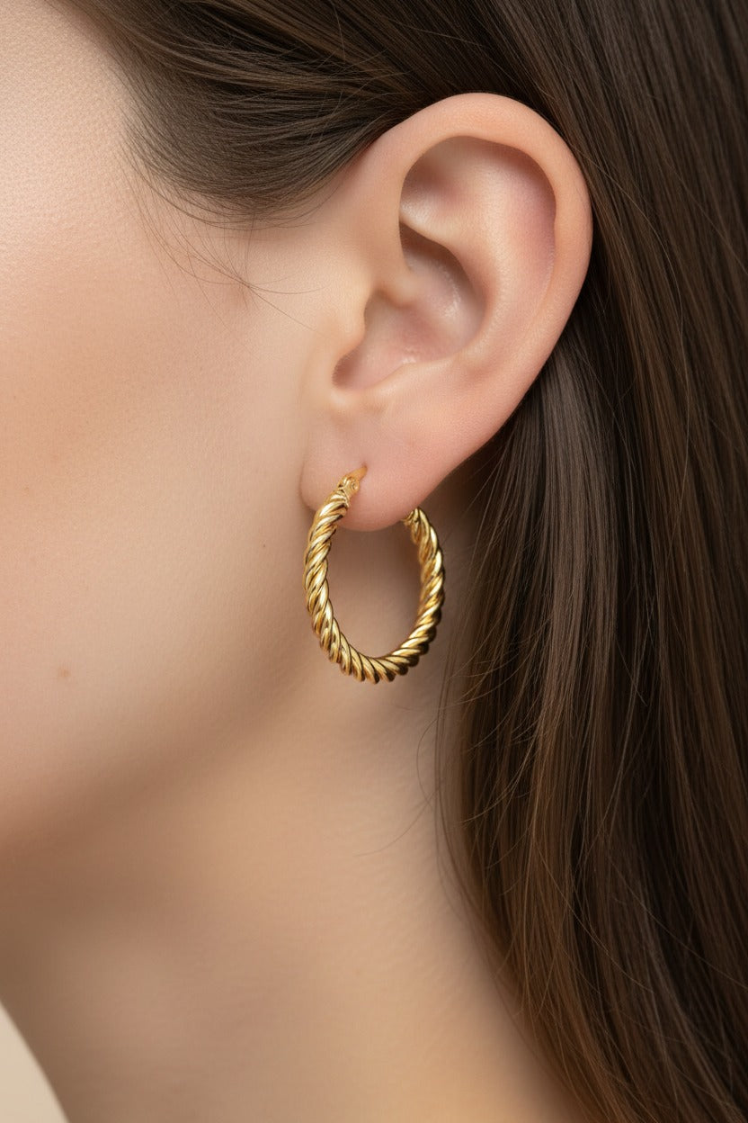 Classic twisted rope hoop earrings in 18K PVD gold plated stainless steel worn on ear