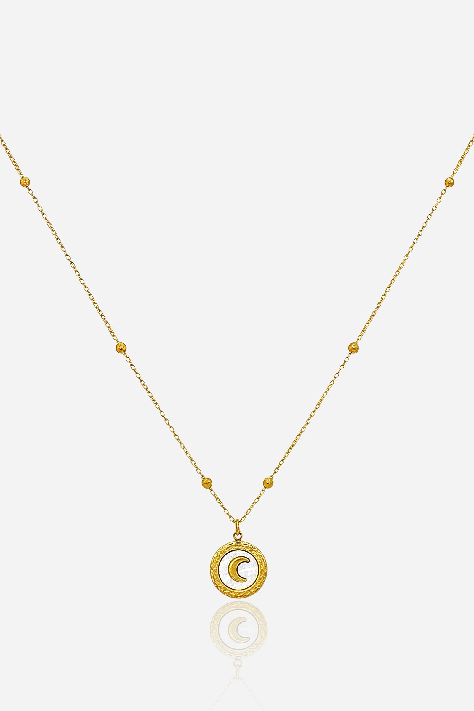Crescent Moon Pendant Necklace in PVD 18K gold plated stainless steel, front view showing textured round medallion on a delicate beaded chain – GLISTIA