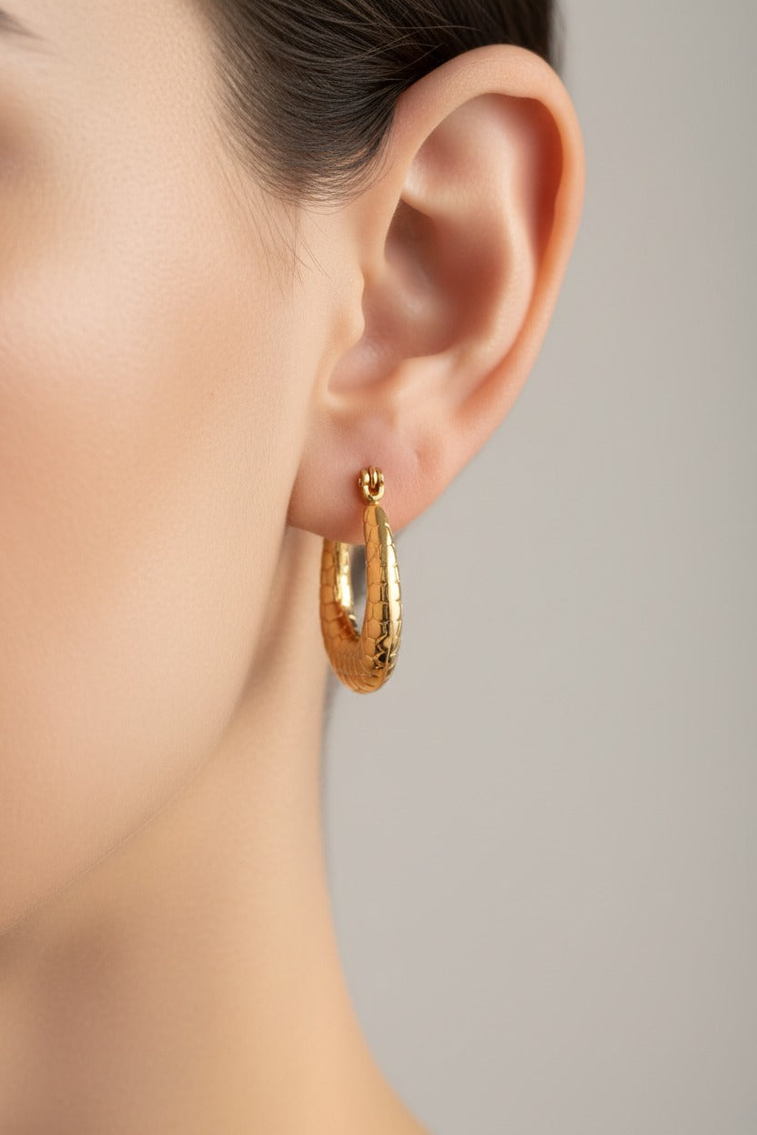 Crocodile texture hoop earrings crafted from stainless steel with 18K PVD gold plating, featuring a bold U-shaped design and embossed reptile-inspired detailing
