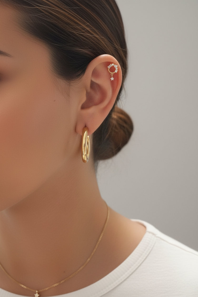 Crystal baguette circle piercing single earrings crafted from stainless steel with 18K PVD gold plating, featuring an open circle design set with baguette and round cubic zirconia crystals