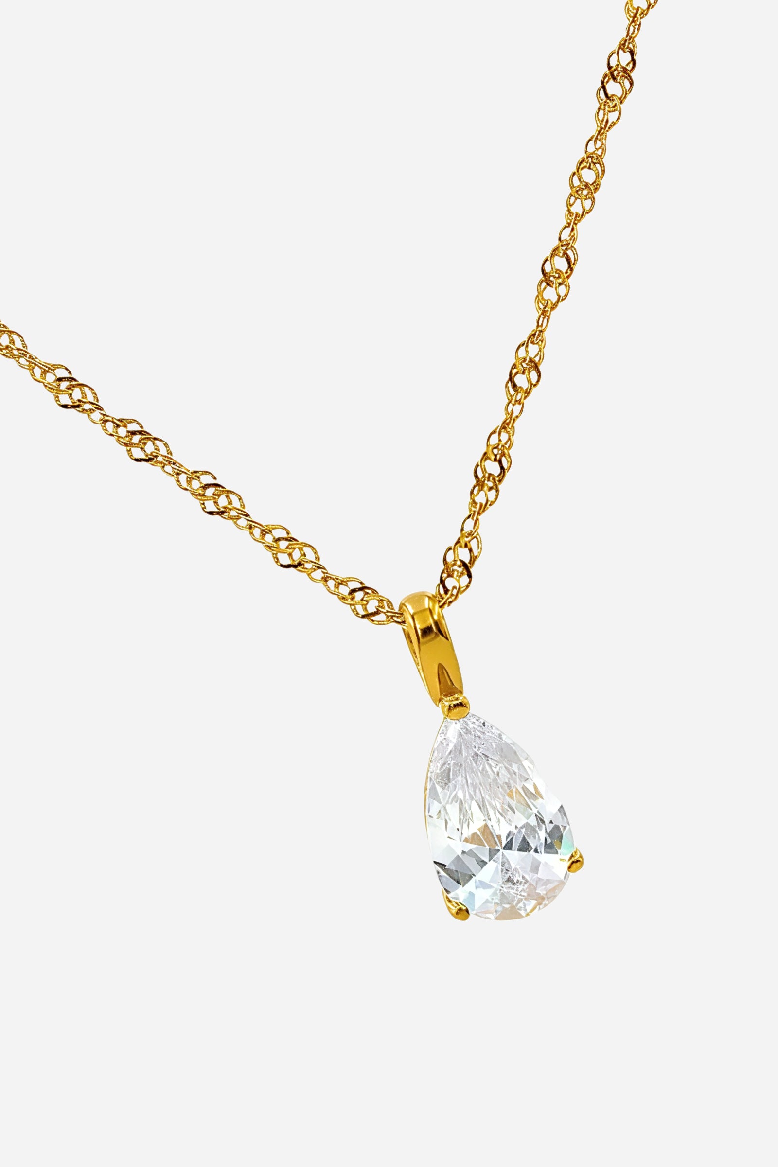 Side angle of April birthstone pendant featuring clear zircon teardrop and gold-plated chain – GLISTIA