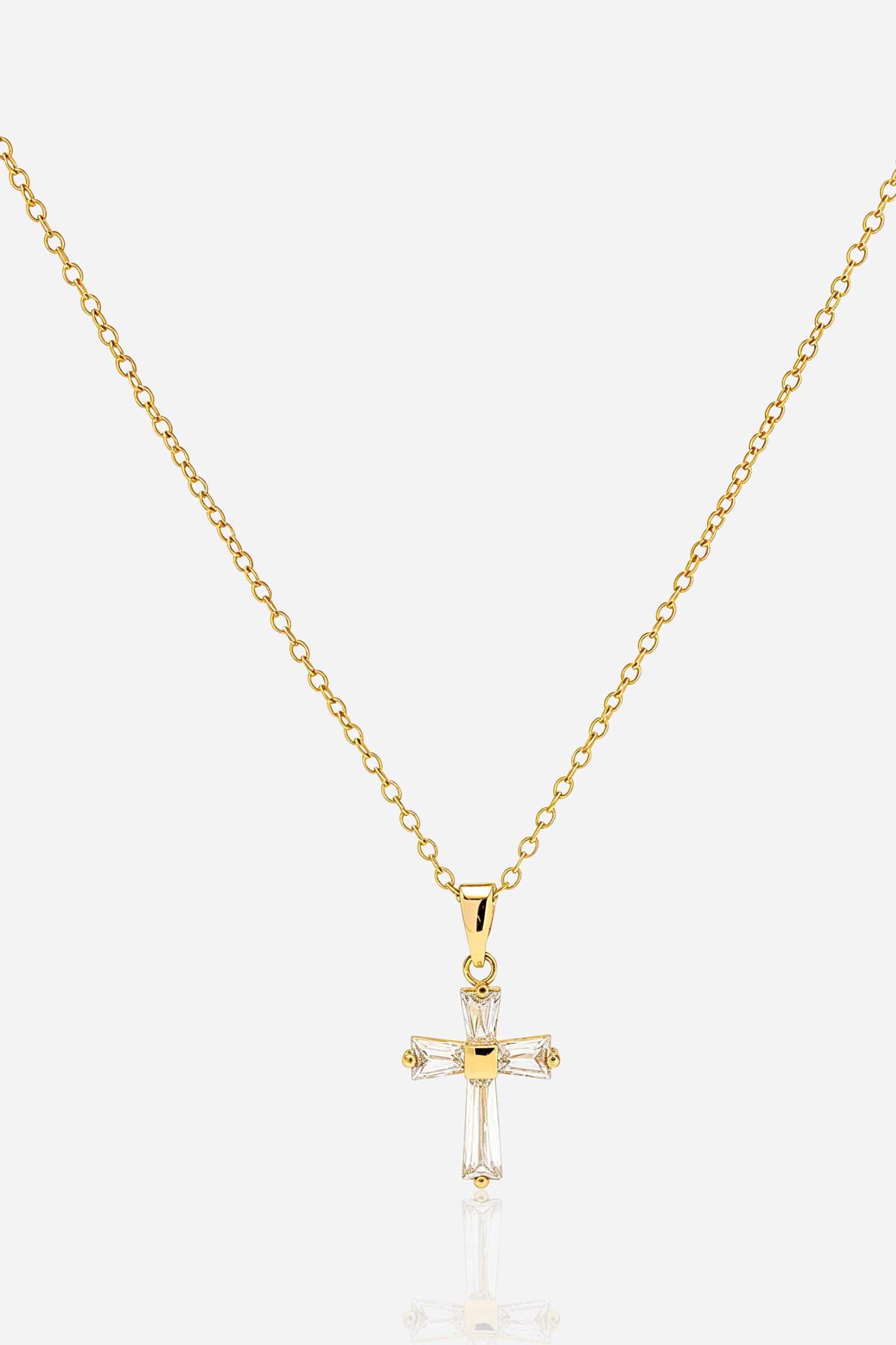 Zoom view image of GLISTIA gold-plated crystal cross necklace on fine-link chain.