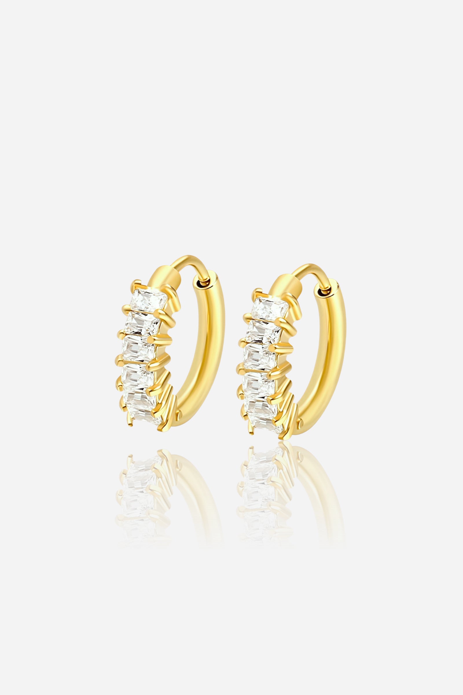 Pair of small hoop earrings crafted from stainless steel with PVD 18K gold plating, featuring prong-set baguette and round cubic zirconia stones for a radiant sparkle – GLISTIA.