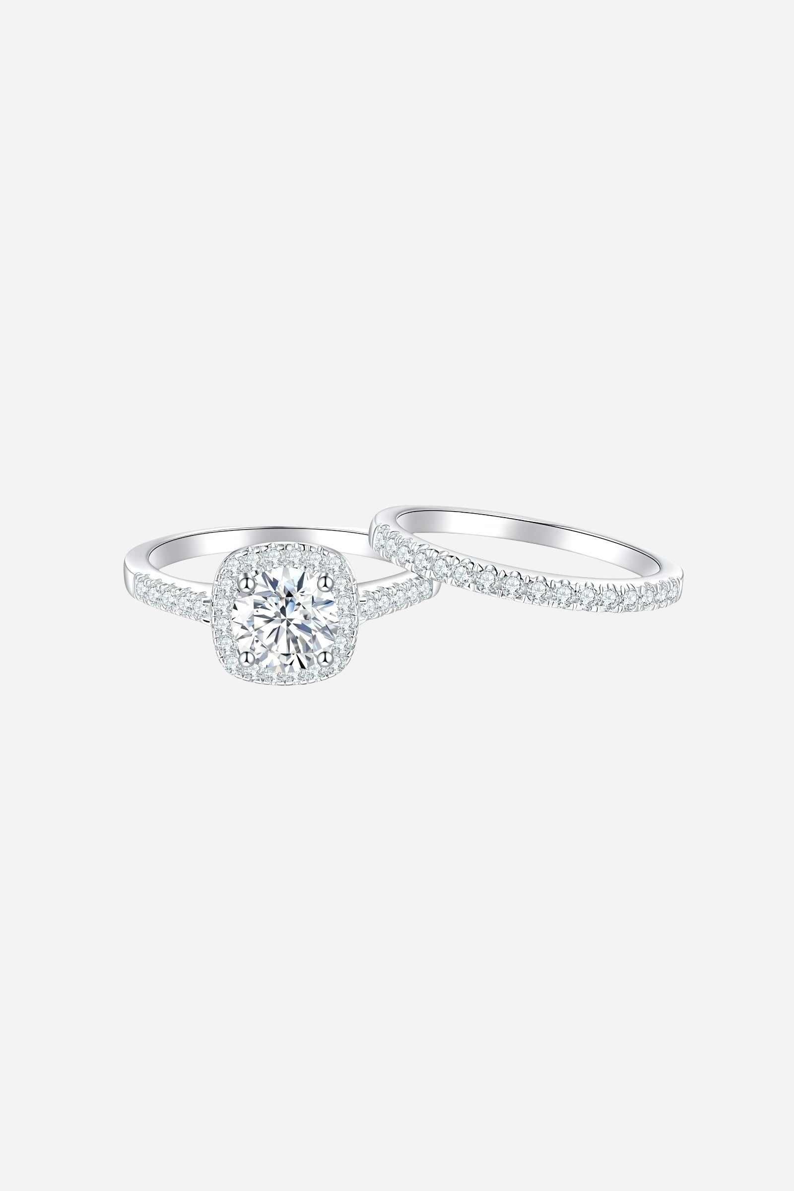 Top-view of GLISTIA sterling silver cushion halo ring featuring pavé-set zircon stones and a mirror-polished finish.
