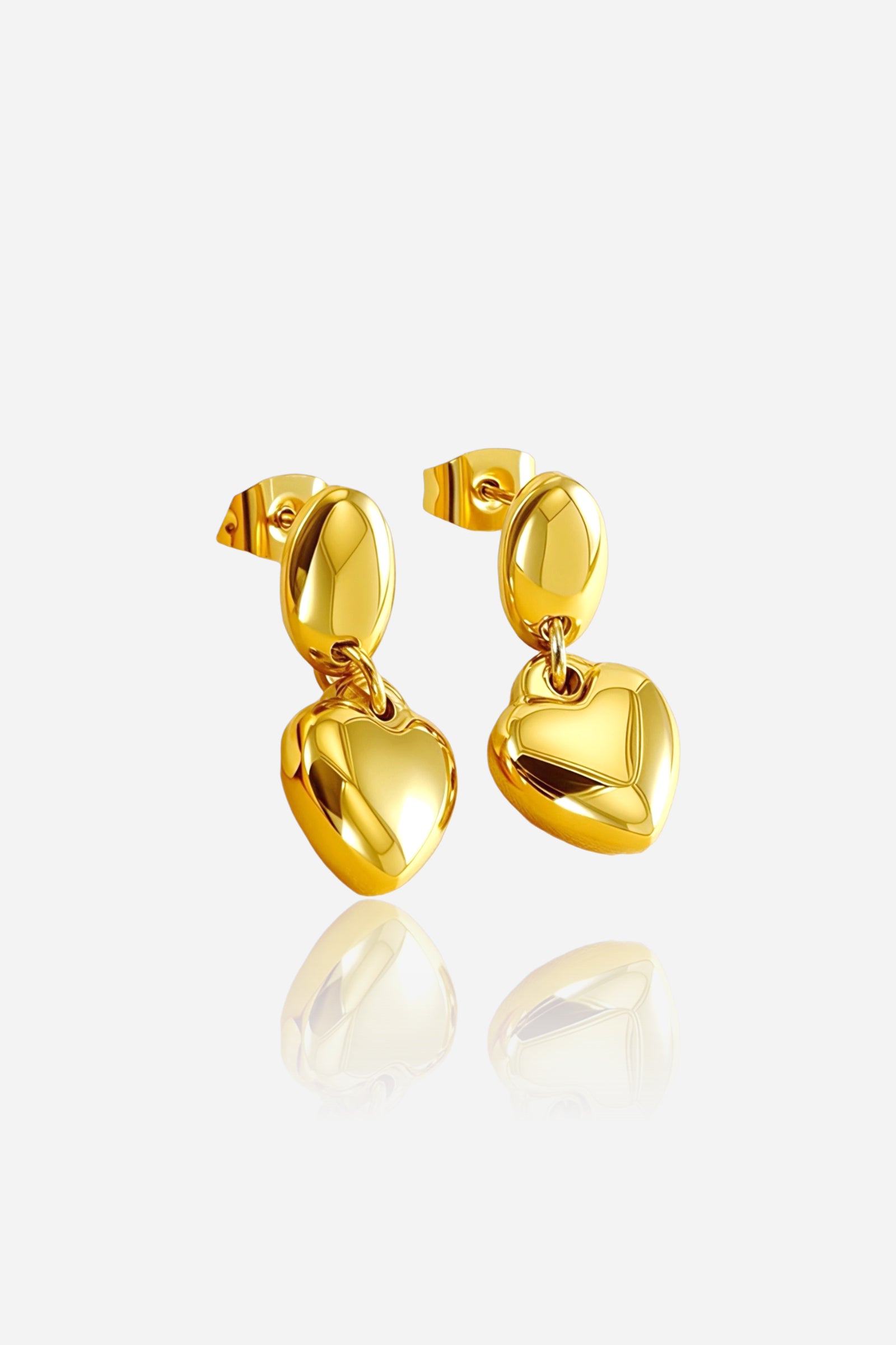 Front view of polished dangle heart earrings crafted from stainless steel with a high-shine PVD 18K gold plated finish, featuring smooth oval tops and hanging heart charms – GLISTIA.