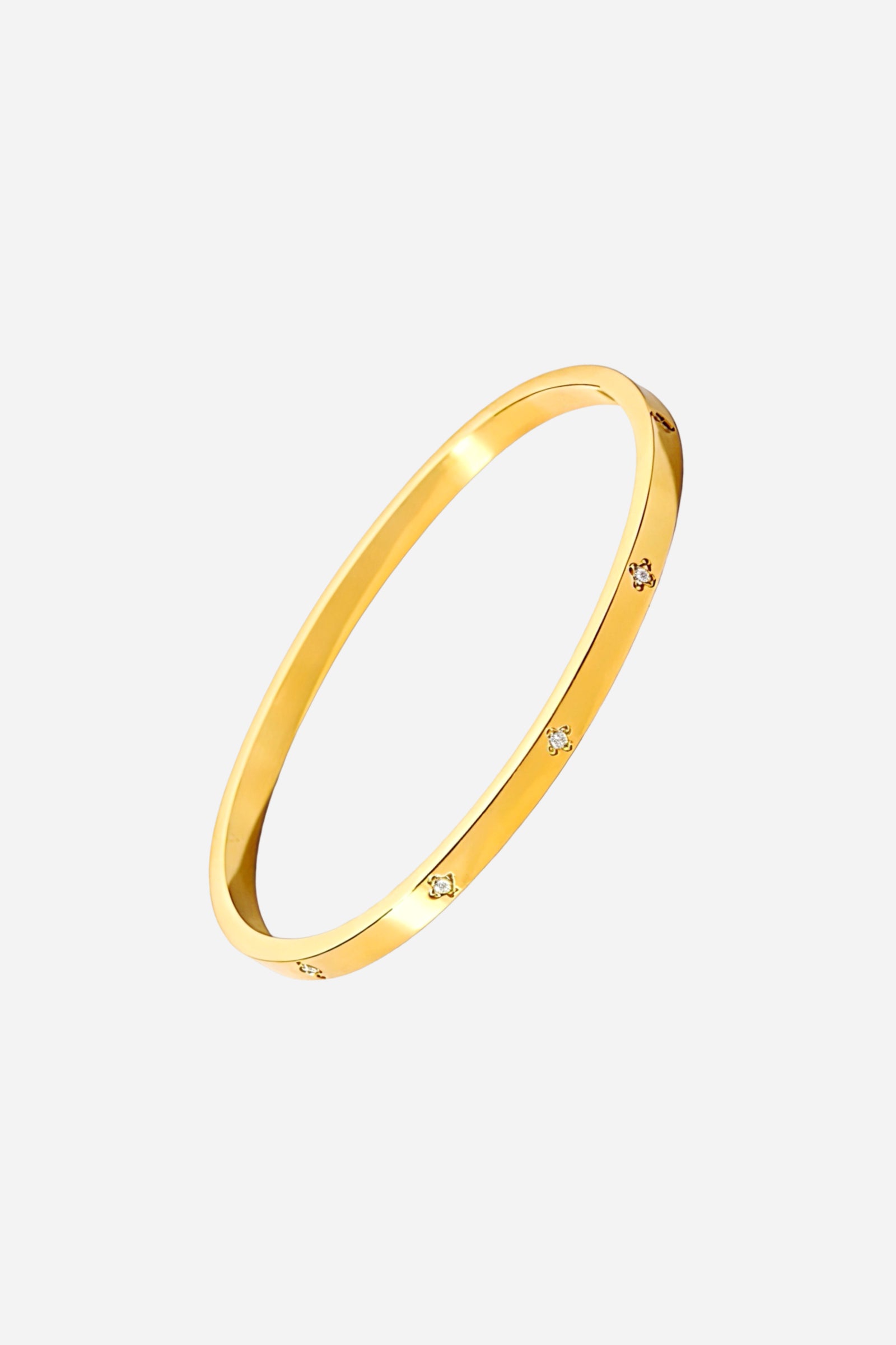 Top view of the slim gold bangle featuring evenly spaced diamond-style cubic zirconia accents – GLISTIA.