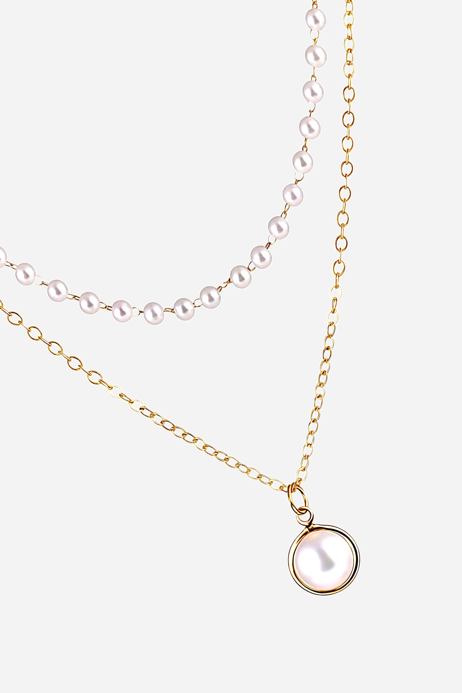 Close-up of double layer gold pearl pendant necklace showing pearl detailing and polished 18K PVD plating – GLISTIA.