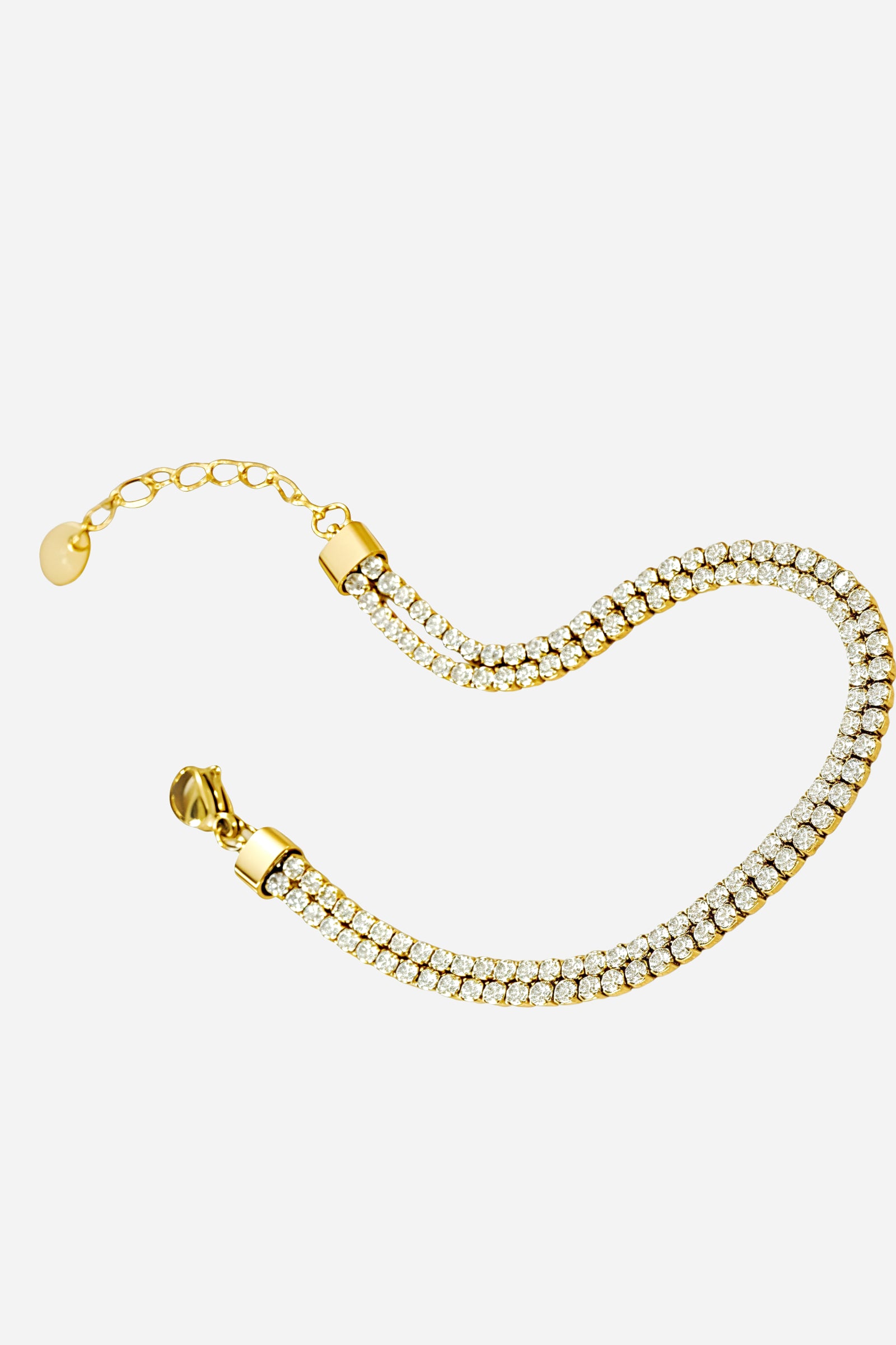 Side-angle view of the GLISTIA PVD 18K gold tennis bracelet highlighting the polished finish and double crystal rows.