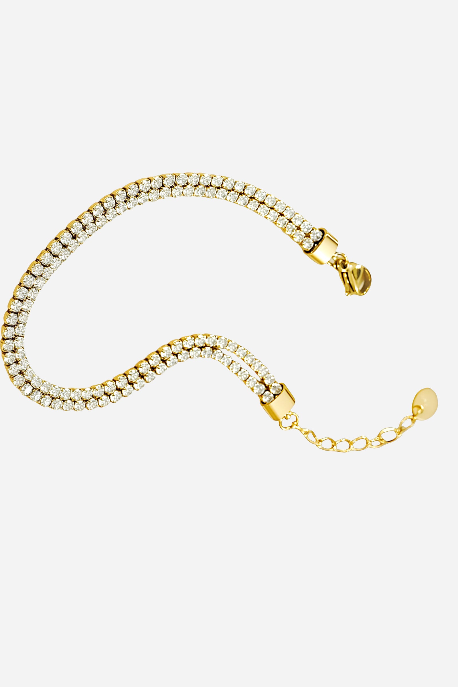 Top-view of GLISTIA’s gold double row tennis bracelet featuring a continuous dual line of brilliant clear crystals.