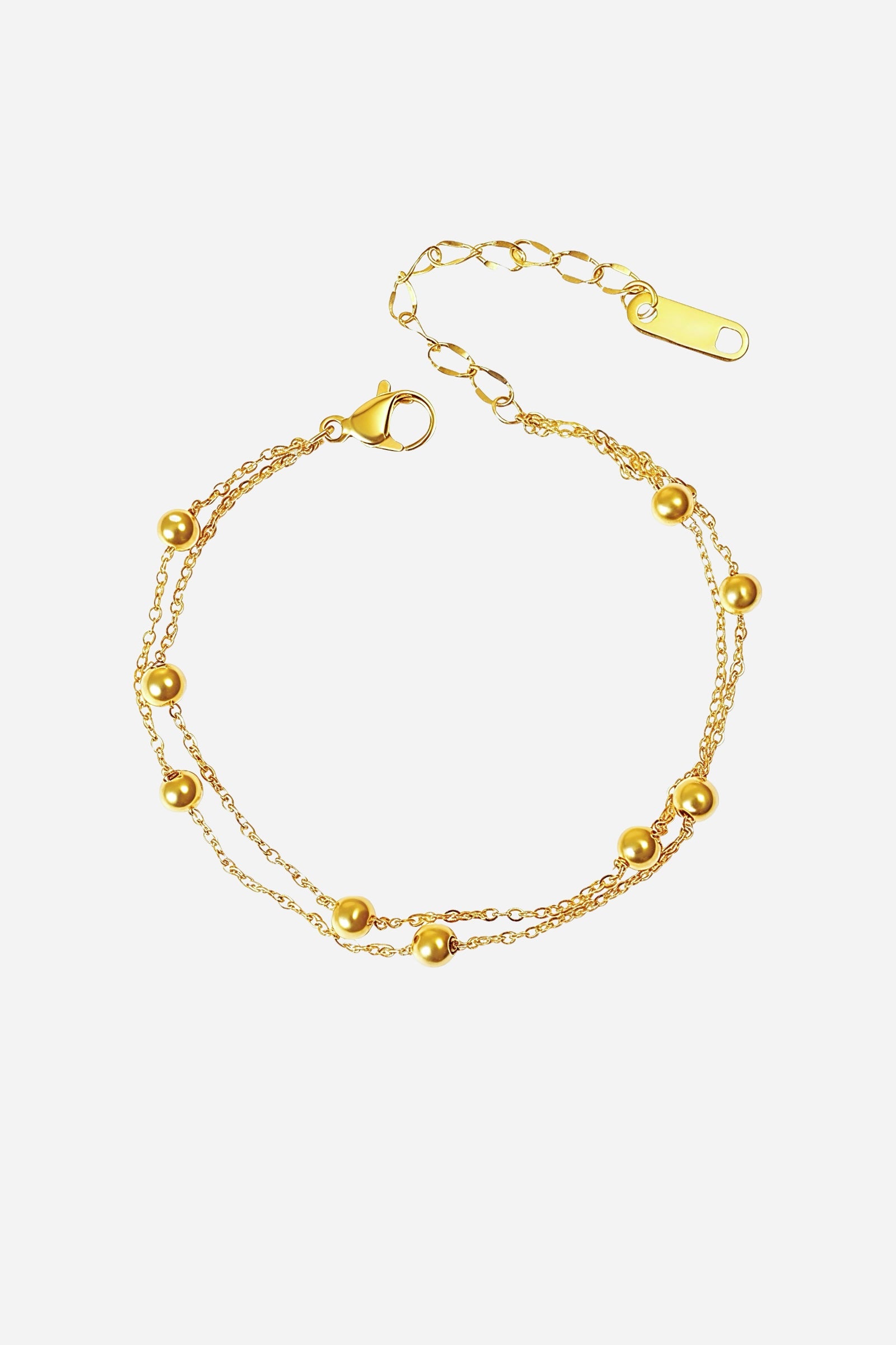 Top-view of GLISTIA’s elegant dual chain bracelet featuring polished gold bead details.