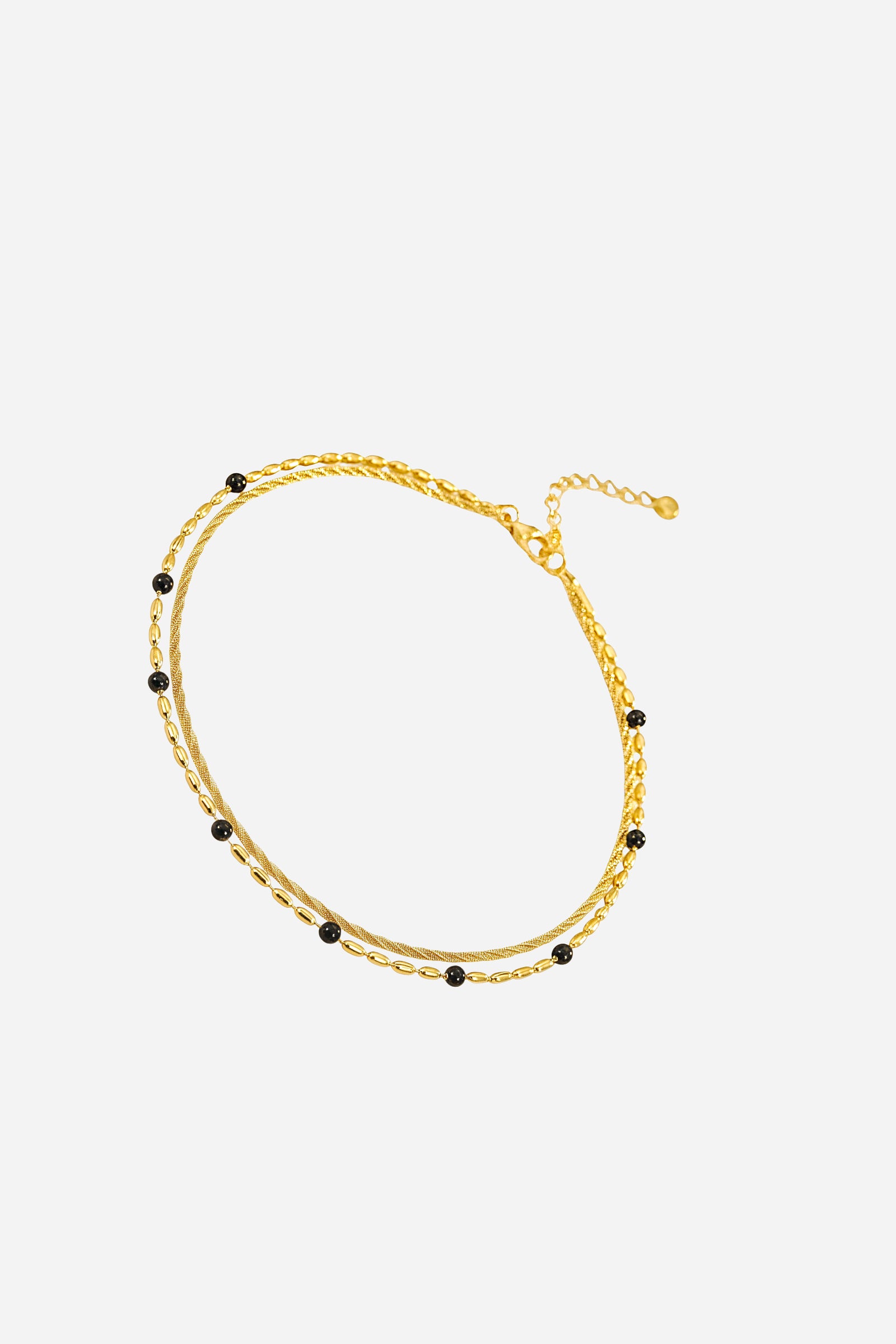 Side angle showing dual chain design with black bead detailing, gold-plated stainless-steel bracelet - GLISTIA.