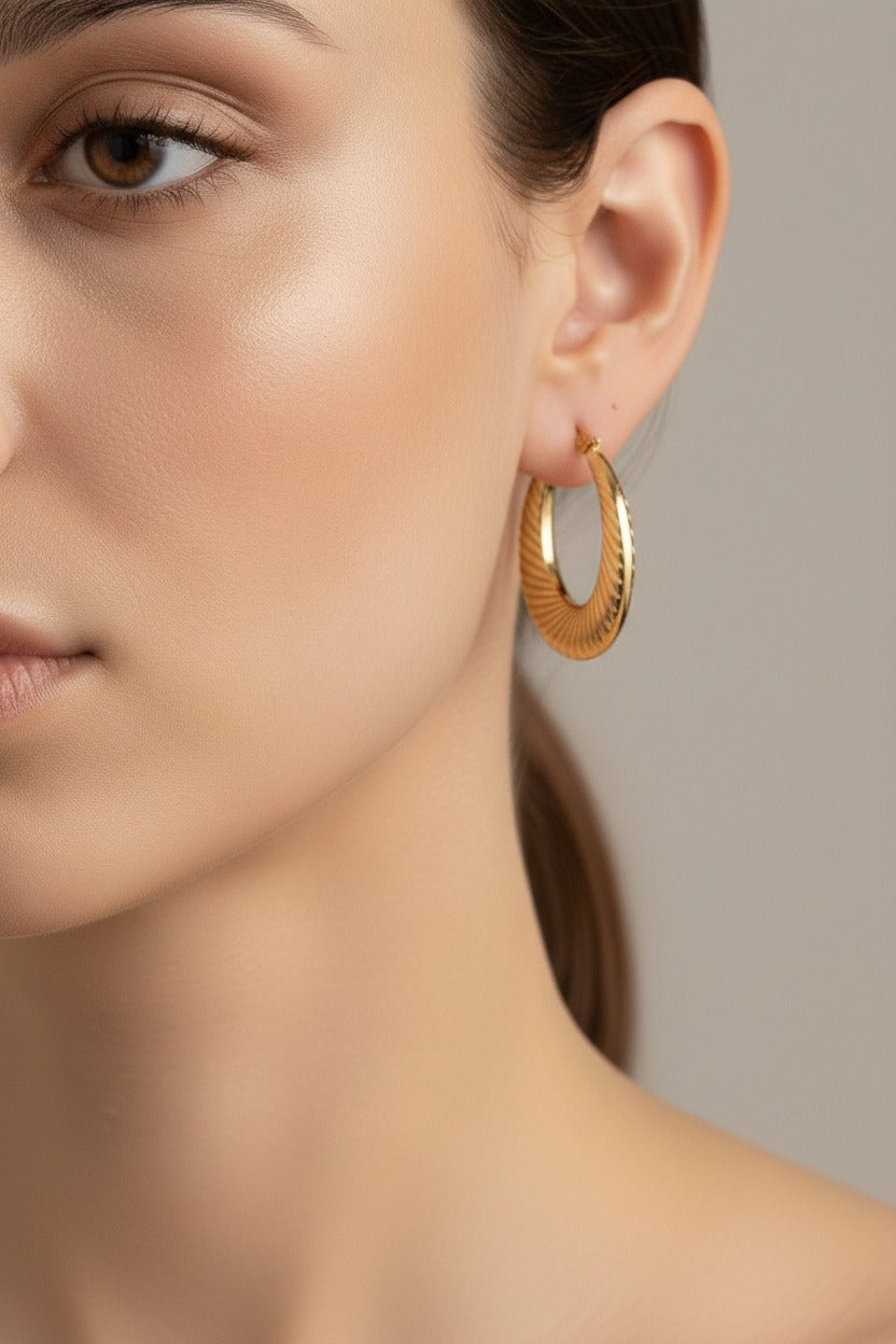 Elara twist hoop earrings worn on ear, crafted from stainless steel with 18K PVD gold plating and rope texture design