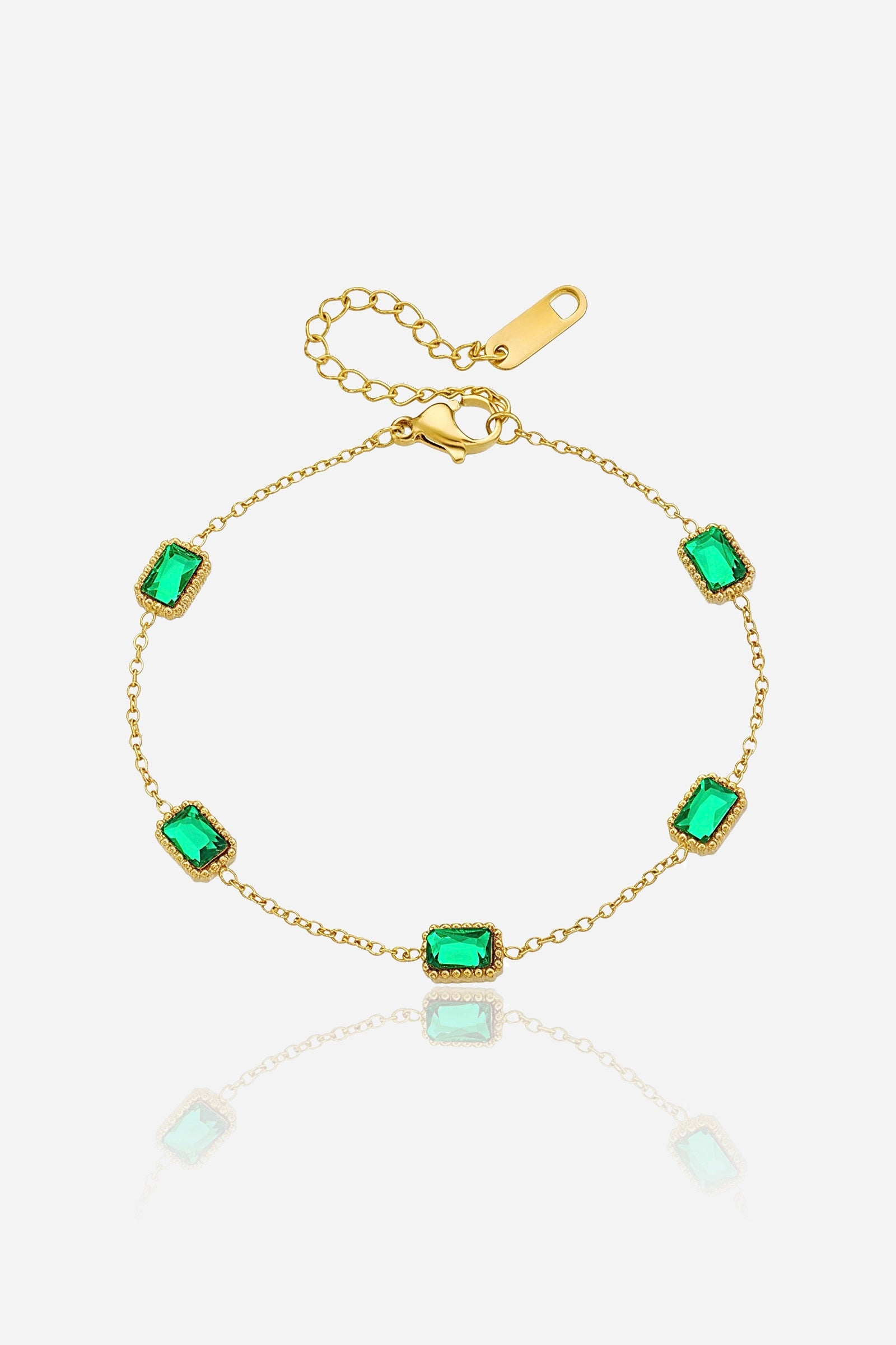 GLISTIA Emerald Chain Luxe bracelet in PVD 18K gold plated stainless steel shown from the front with rectangular-cut emerald stones.