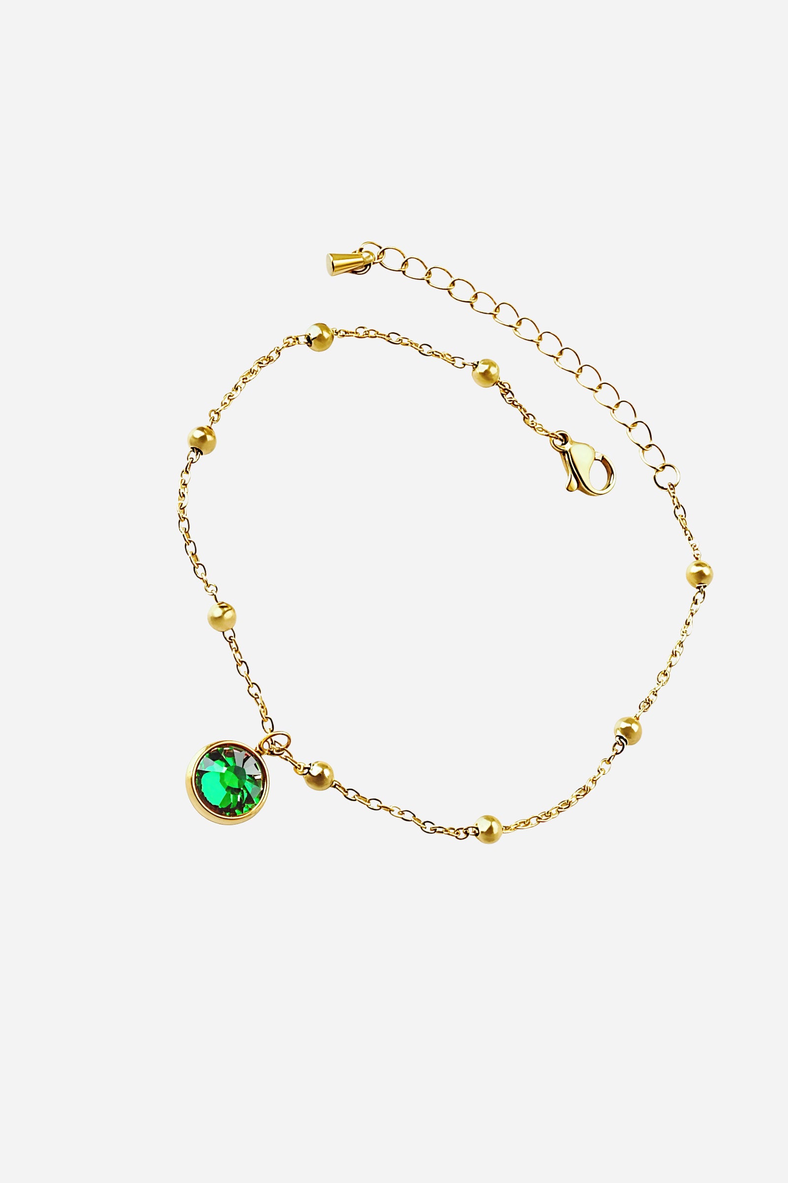 Front view of the Emerald Glow Beaded Anklet in stainless steel with PVD 18K gold plating, featuring a green crystal charm and beaded chain - GLISTIA.