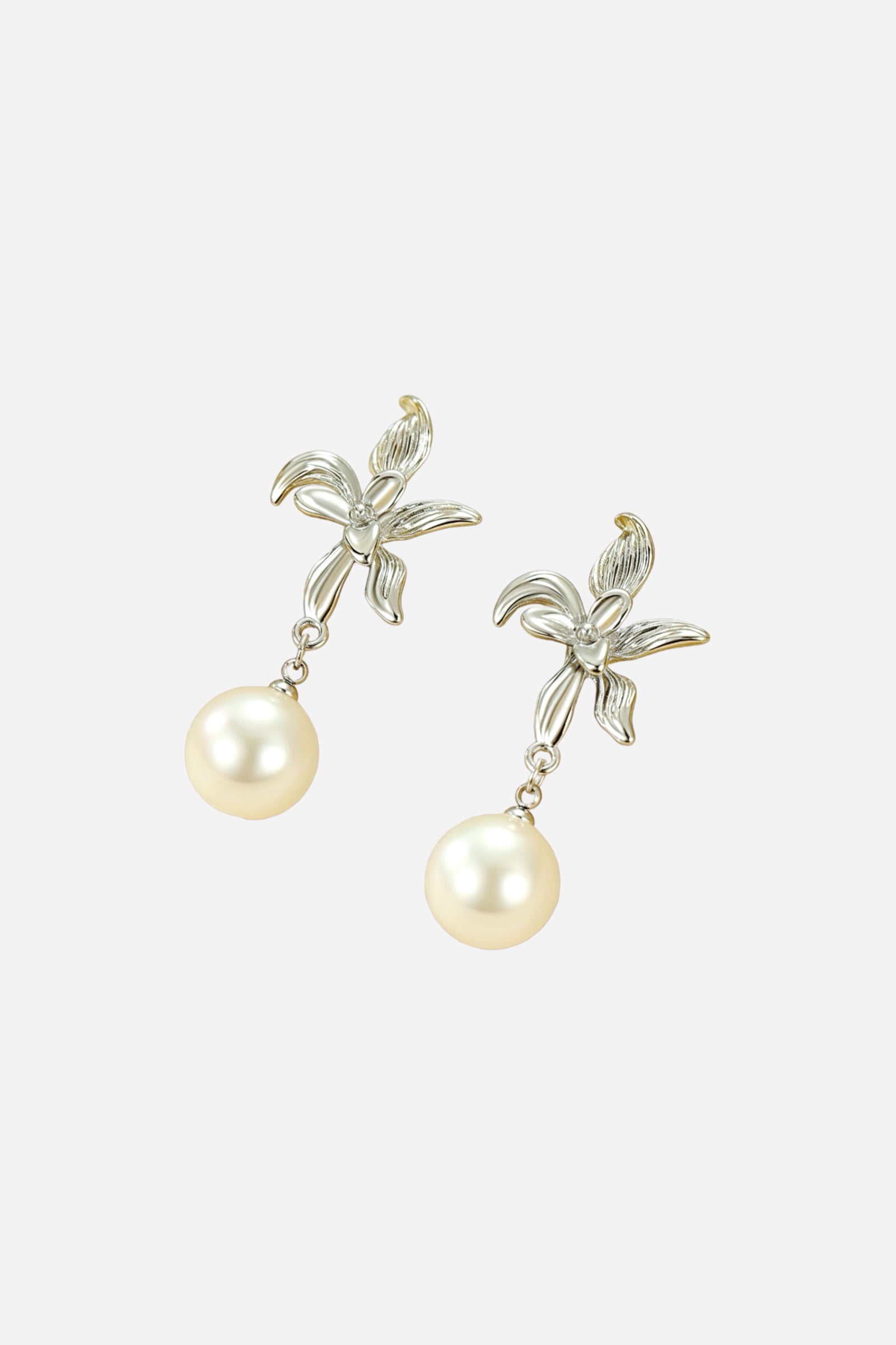 Elegant floral pearl dangle earrings with silver-tone stainless-steel flower design and imitation pearl drops, featuring fine petal detailing and a radiant polished finish – GLISTIA.