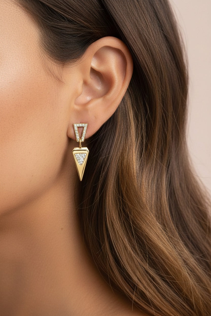 Geometric triangle drop earrings crafted from stainless steel with 18K PVD gold plating, featuring crystal-framed triangular drops.