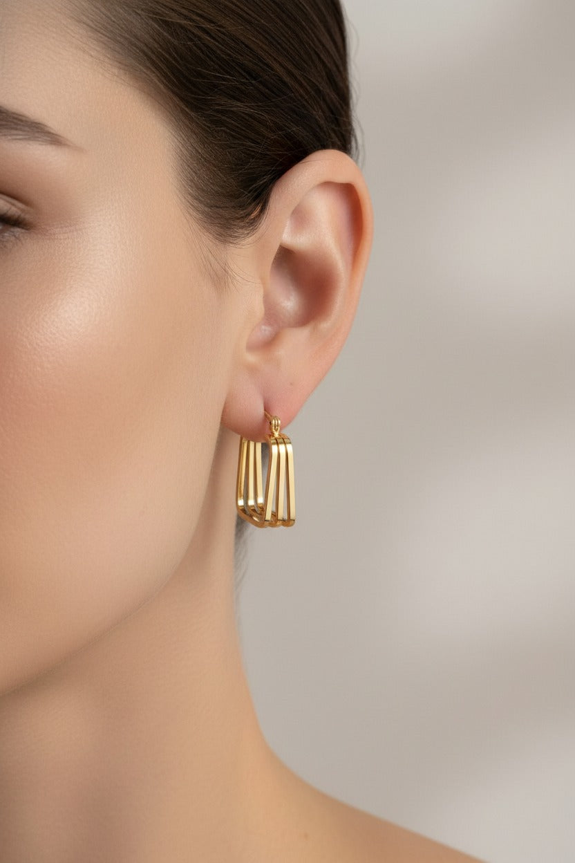 Side view of geometric multi-bar hoop earrings with layered gold design in 18K PVD gold plated stainless steel.