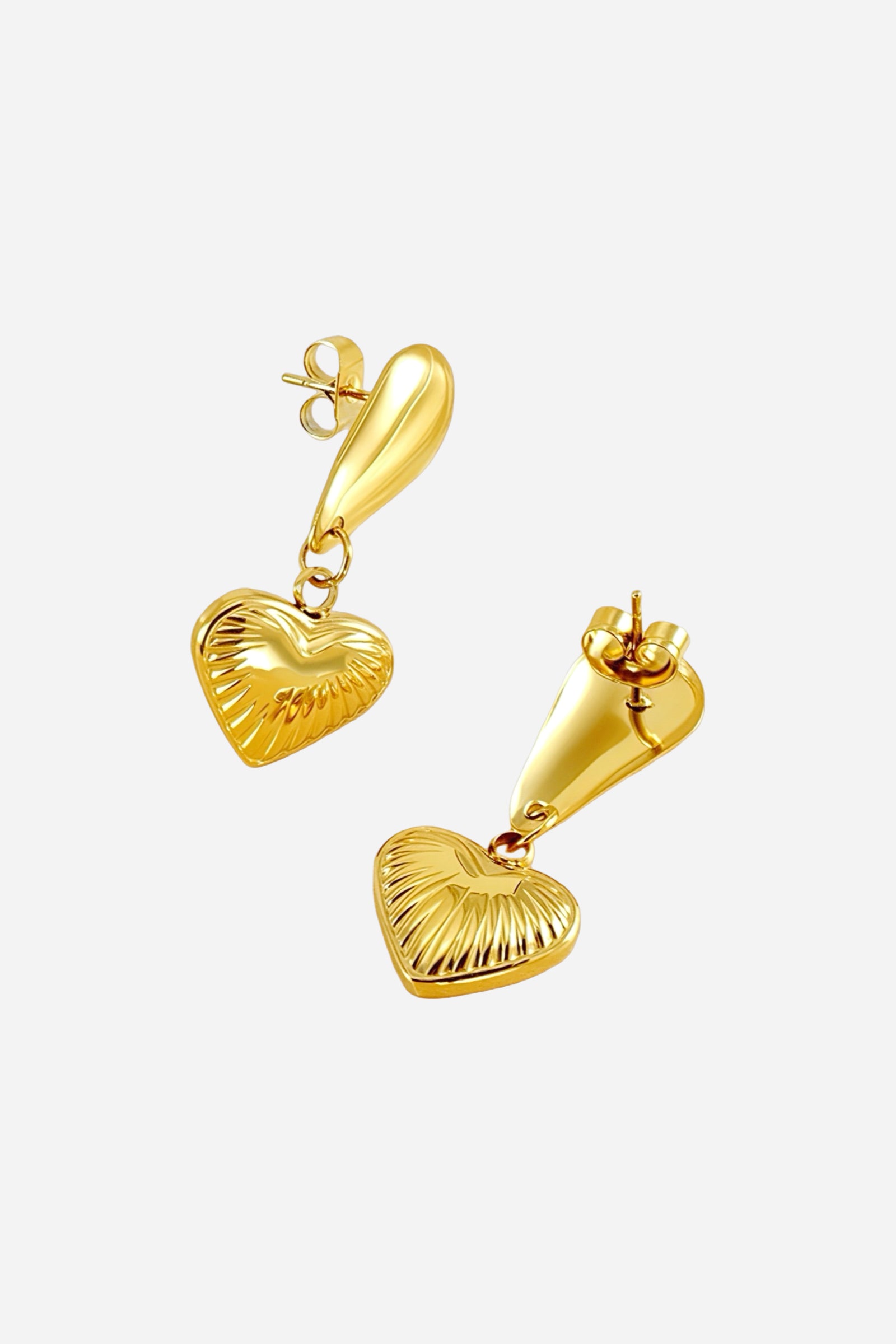 Side view of textured heart drop earrings crafted from stainless steel with a radiant PVD 18K gold-plated finish, featuring elongated teardrop studs and embossed heart charms — GLISTIA.