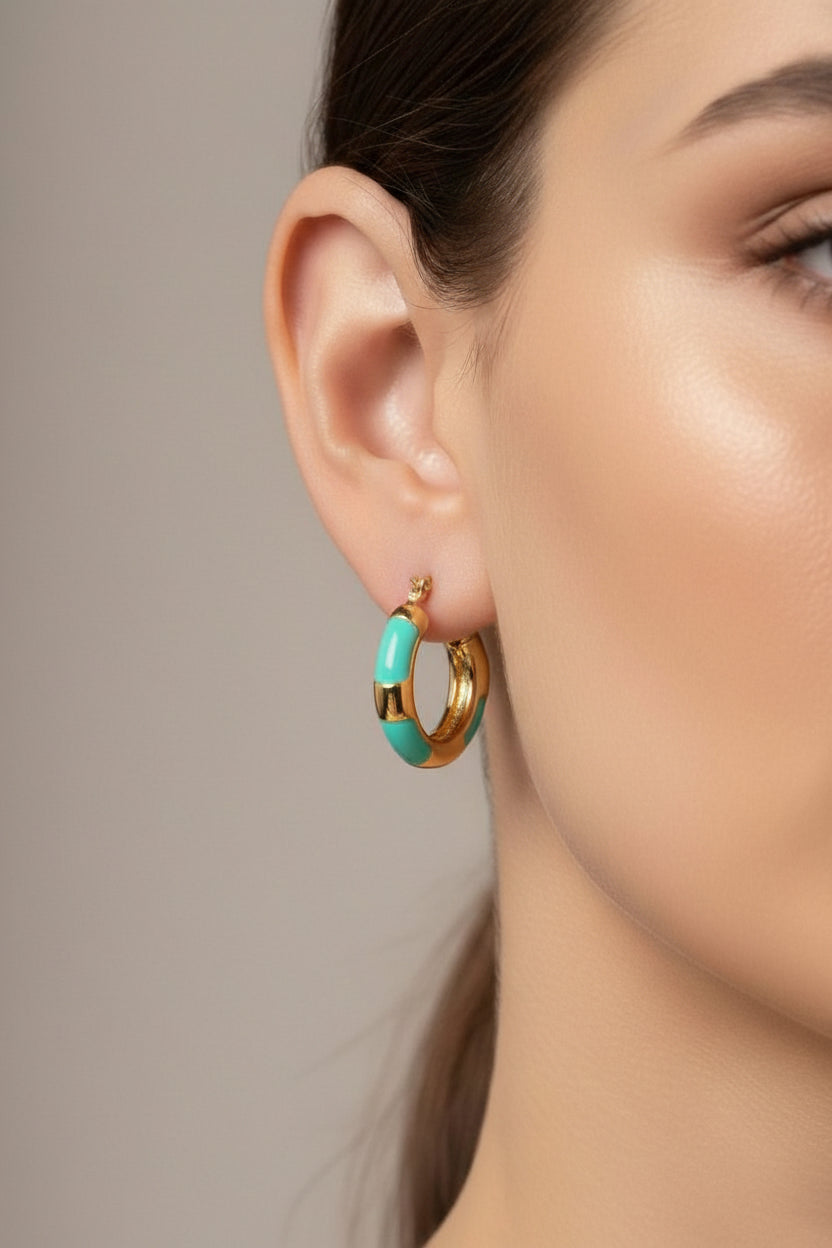 Turquoise bamboo-inspired hoop earrings in 18K PVD gold plated stainless steel worn on ear