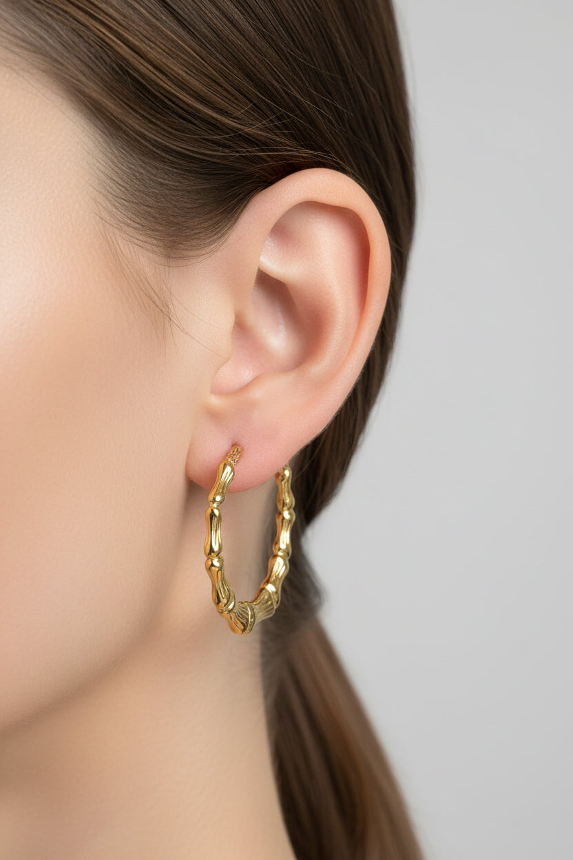 Gold bamboo hoop earrings crafted from stainless steel with 18K PVD gold plating, featuring a textured bamboo-style design and polished finish
