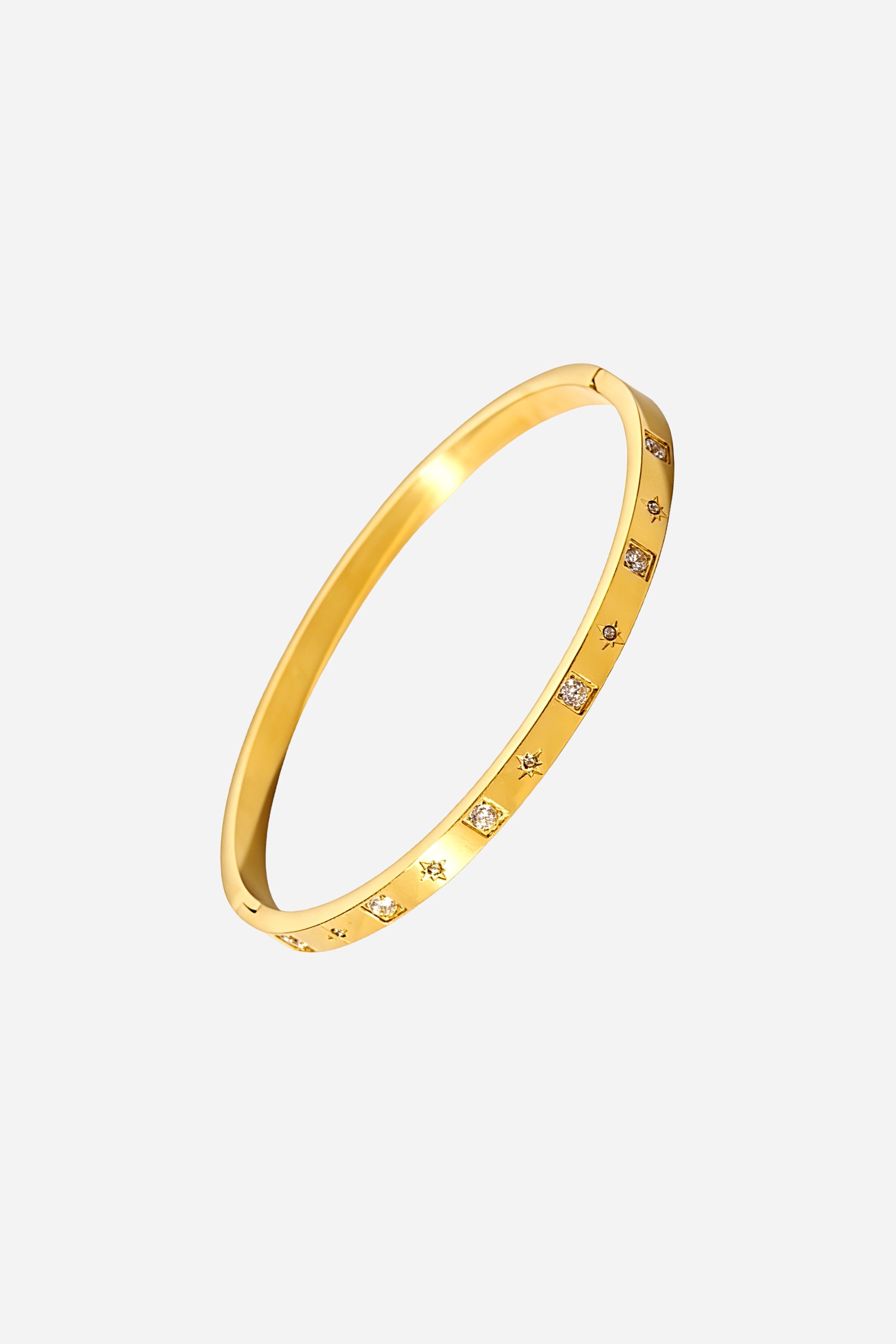 Side profile of GLISTIA Gold Cubic Accent Bangle showing the slim metallic band with precisely inset cubic stones across the golden surface.
