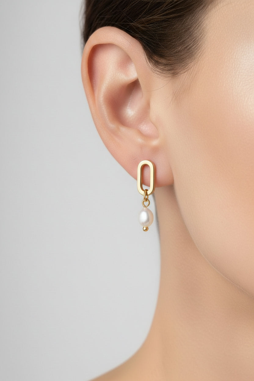 Gold link pearl drop stud earrings worn on ear in 18K PVD gold plated stainless steel