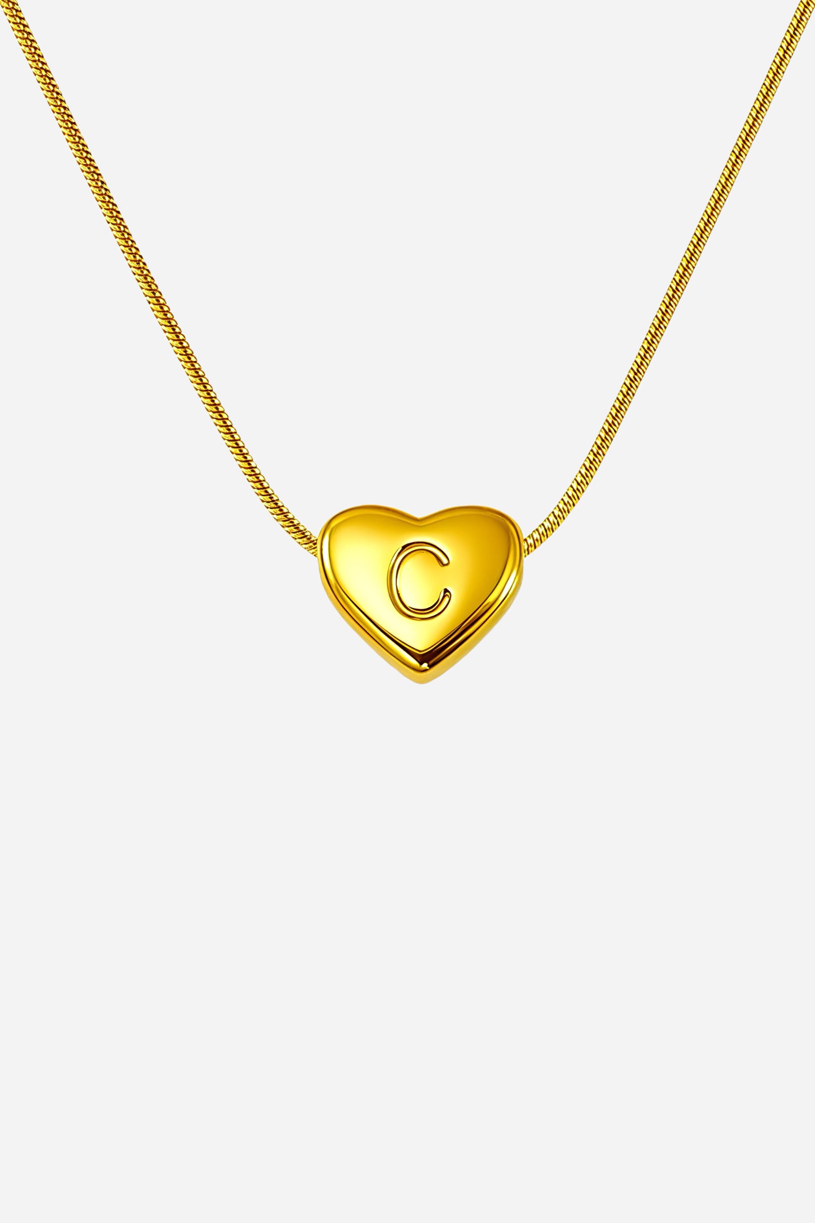 Close-up of gold-plated heart pendant with engraved letter ‘C’, premium stainless steel jewellery - GLISTIA