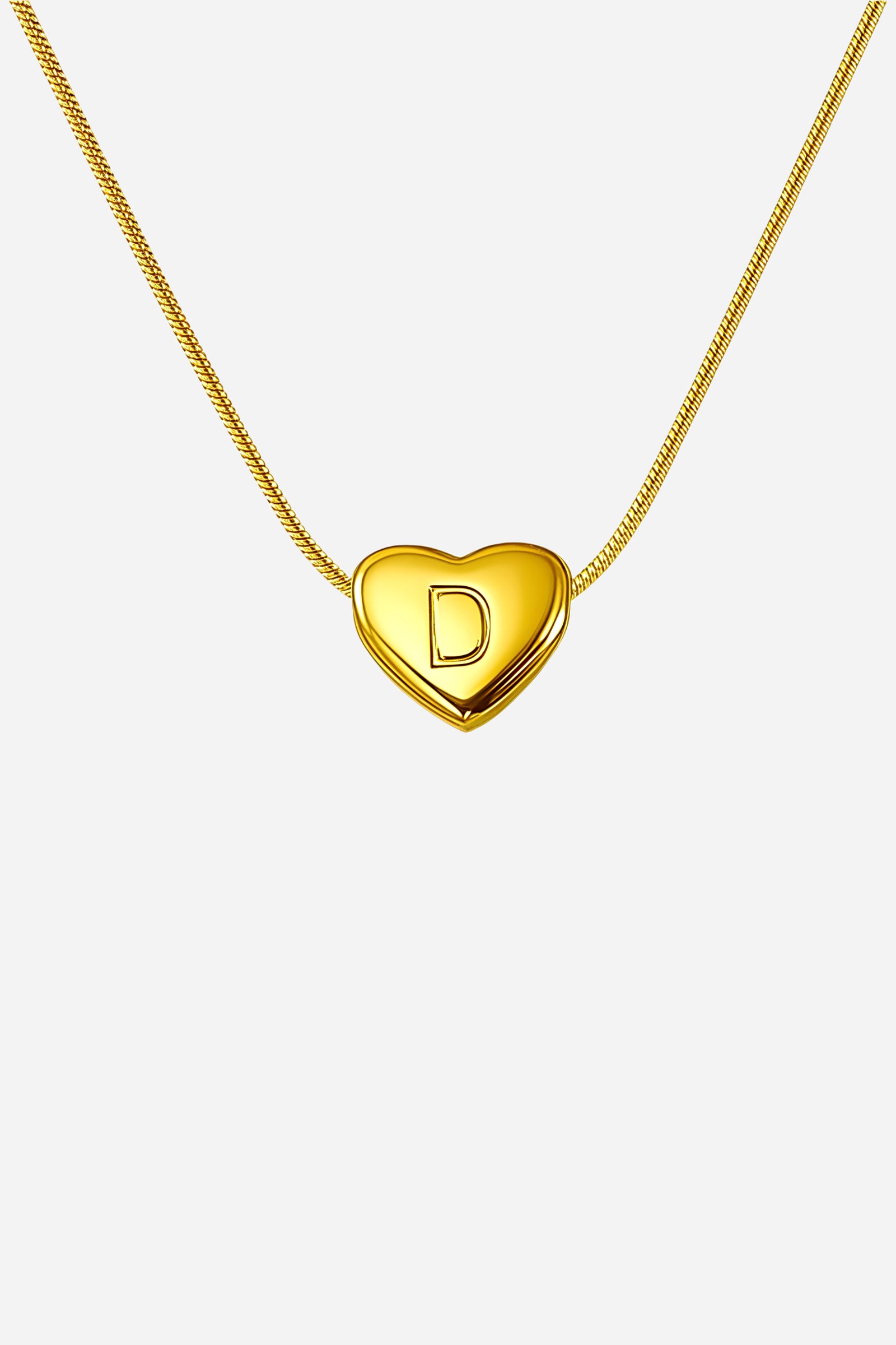 Close-up of engraved heart initial ‘D’ pendant necklace in 18K PVD gold plating – GLISTIA.