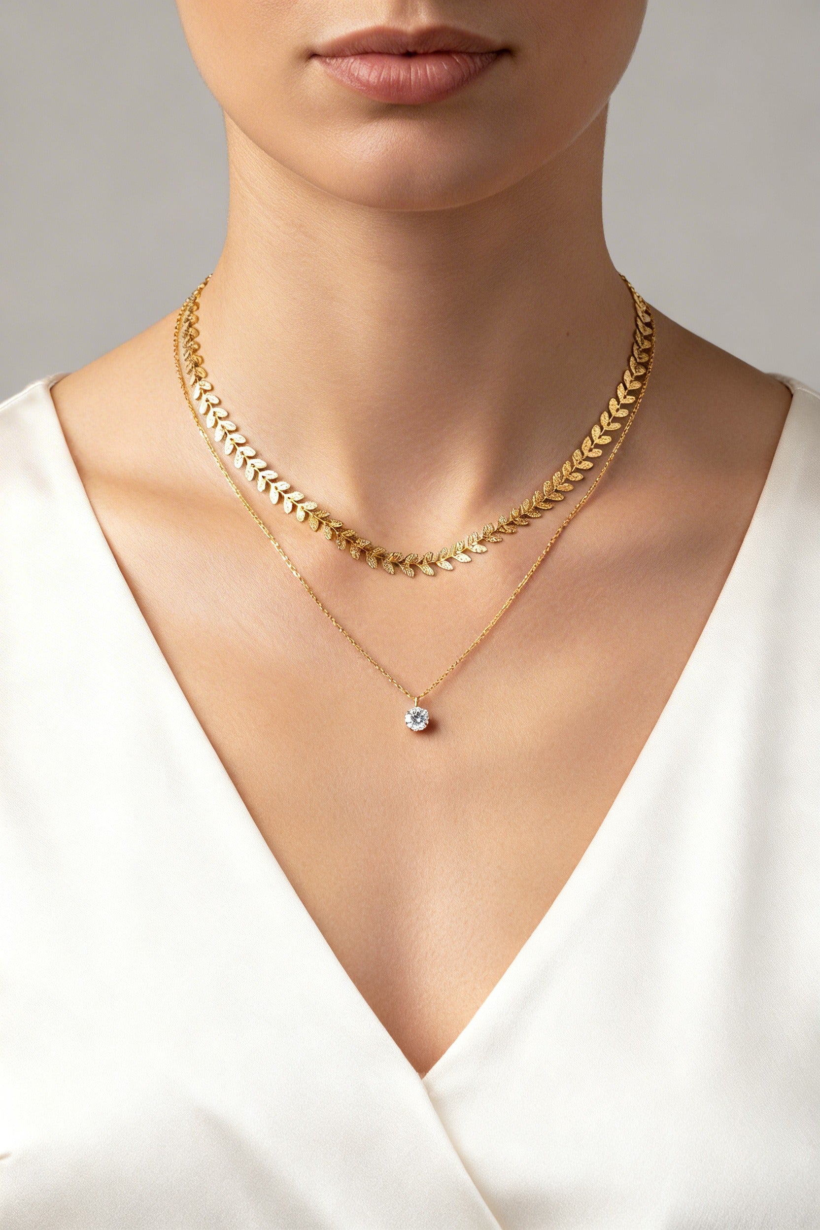 Gold-plated leaf layered necklace with laurel leaf chain and solitaire pendant in stainless steel by GLISTIA