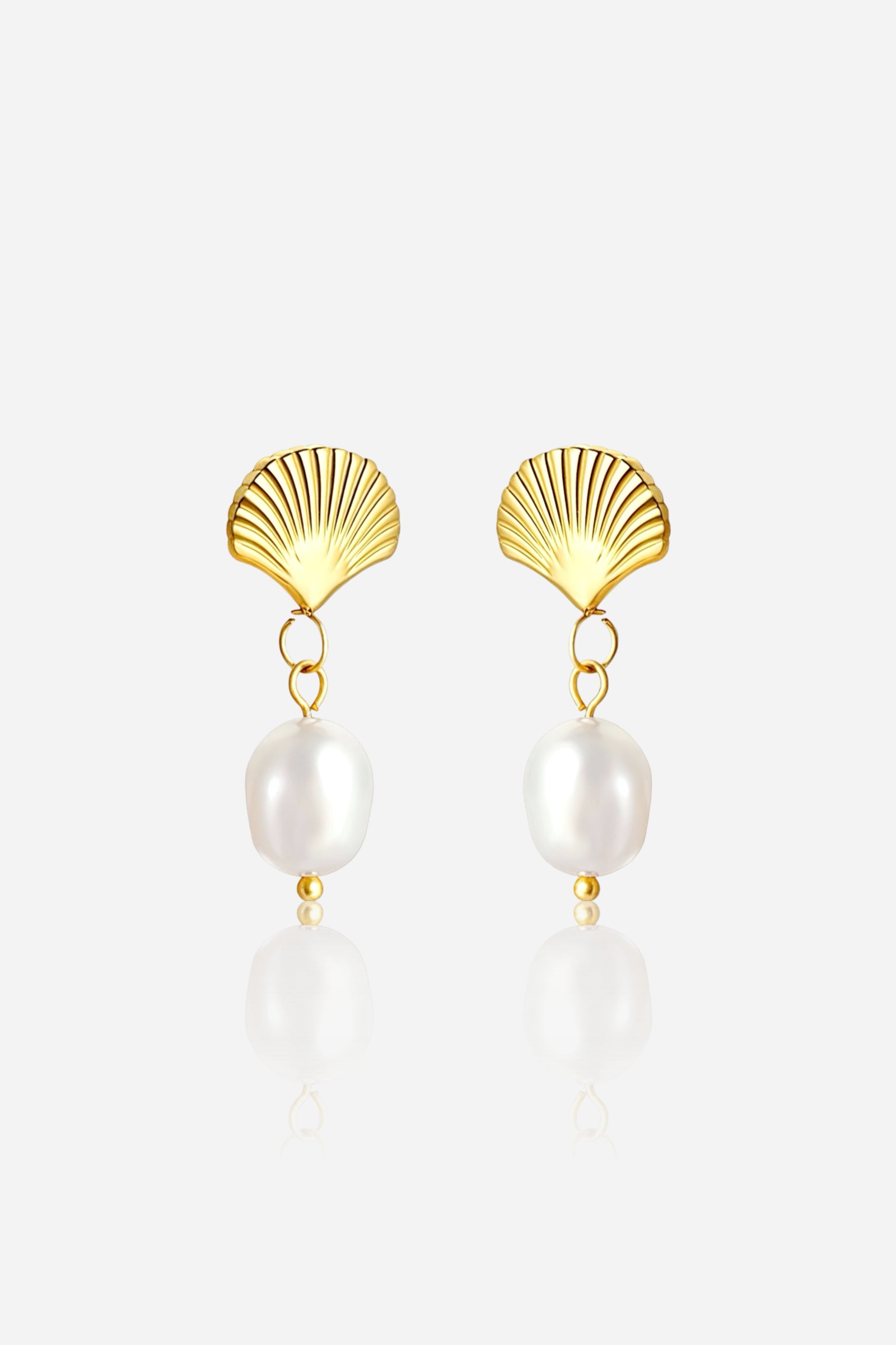 Front view of gold shell pearl drop earrings crafted from PVD 18K gold plated stainless steel, featuring sculpted seashell tops with elegant white pearl accents – GLISTIA.