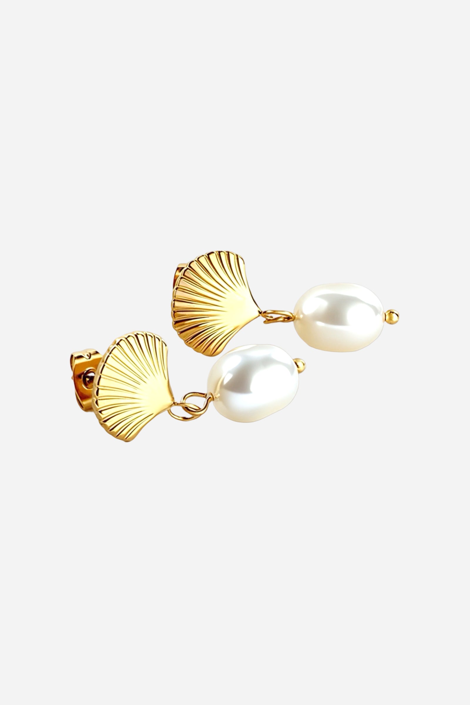 Side angled view of gold shell pearl drop earrings featuring fan-shaped textured shells with white pearl drops, crafted in PVD 18K gold plated stainless steel – GLISTIA.