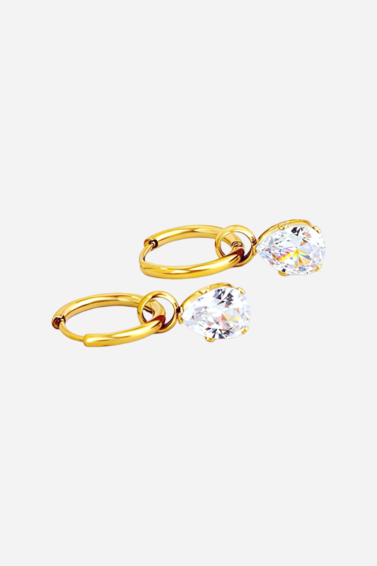 Close-up of gold teardrop crystal drop hoop earrings crafted from stainless steel with a polished PVD 18K gold-plated finish, featuring a sparkling teardrop crystal suspended from sleek hoops – GLISTIA